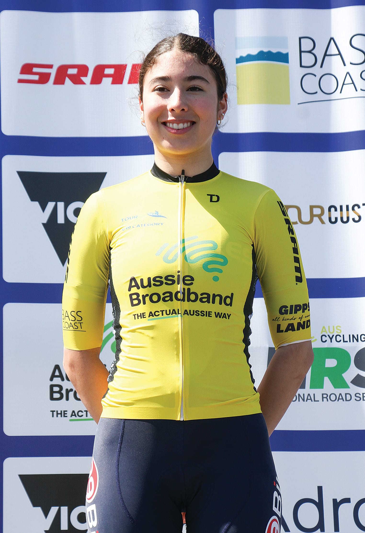 U19 women’s race winner Emma Ochoa (99Bikes Race Team) accepting the yellow jersey at Phillip Island. B08_4124