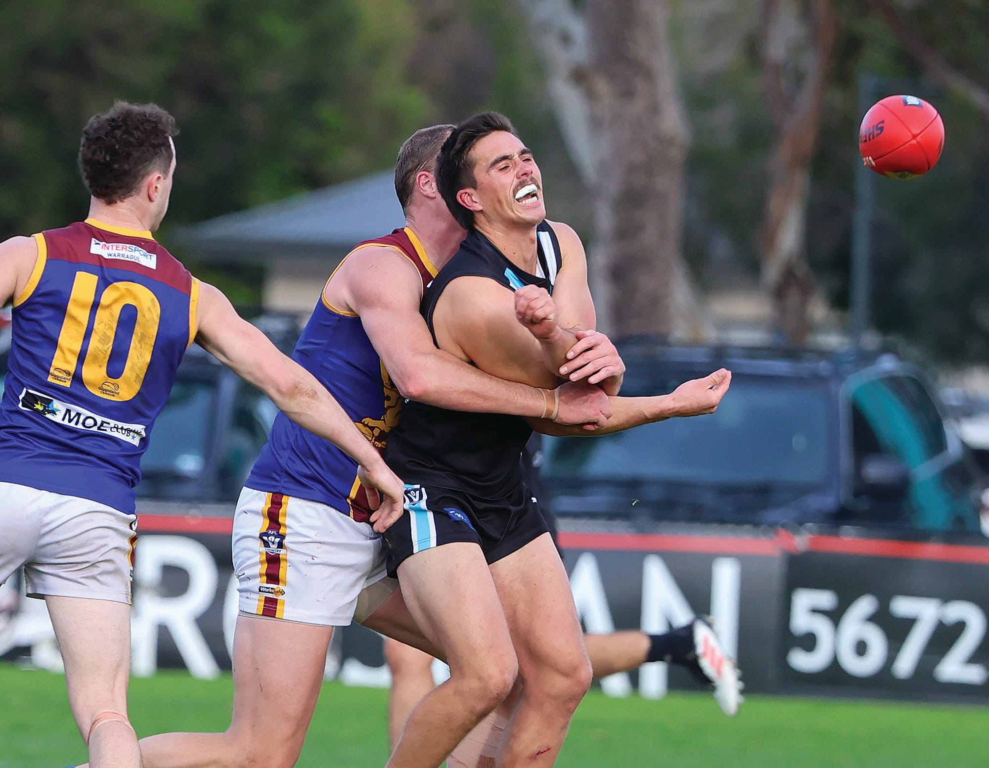 Wonthaggi playmaker Ryan Sparkes still manages to get his handpass away under immense pressure in the centre. He kicked two goals and was one of Power’s winners on a tough day.
