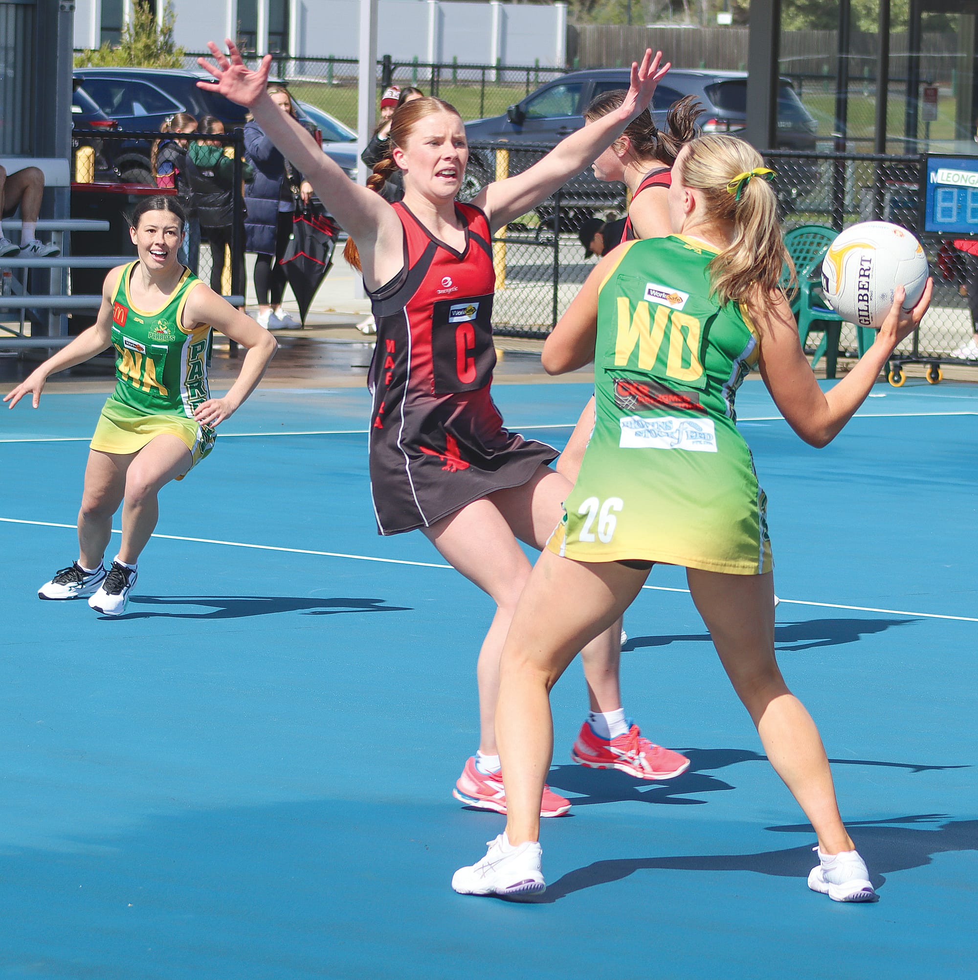 Madeline Caddy has ball in hand for Leongatha as Maffra’s Chloe Rees applies pressure. A24_3723