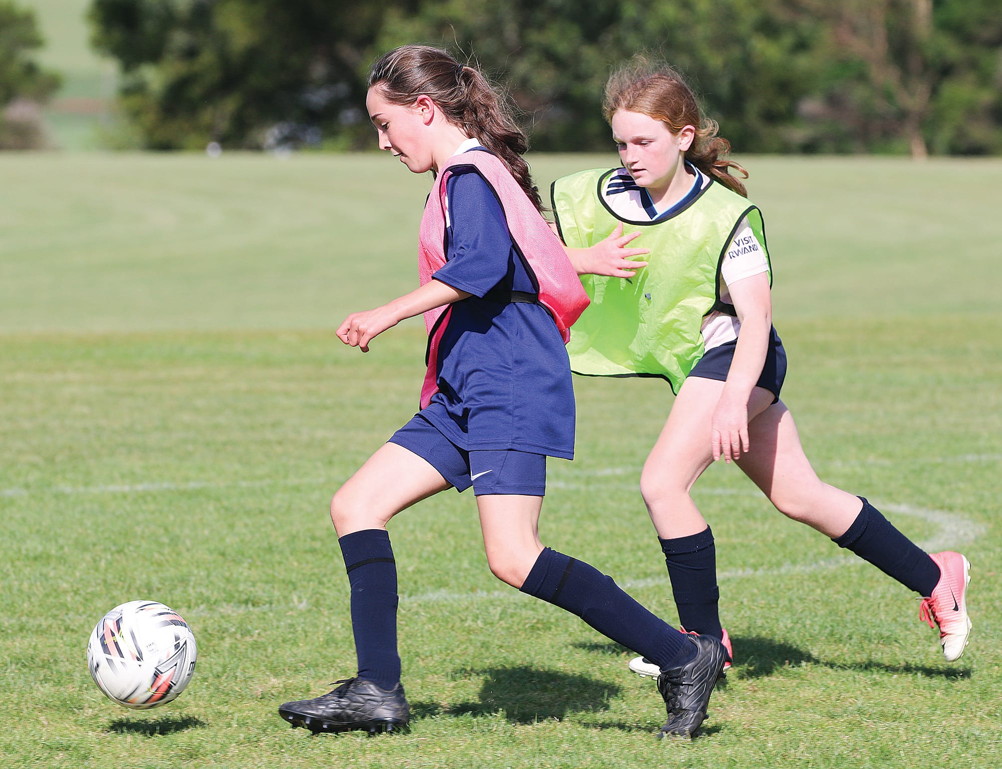 Lulu Richards keeps possession of the ball with Caitlyn Goodwin in pursuit. 