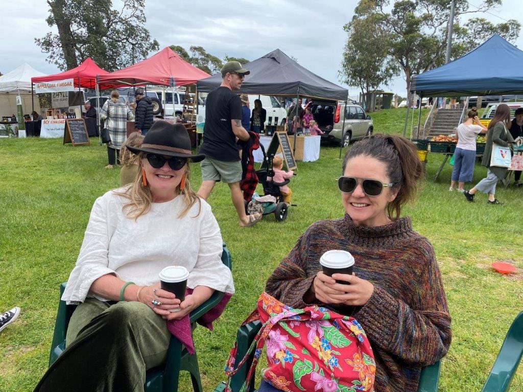 Two locals enjoying the Inverloch Farmers Market on a rare dry day last month.