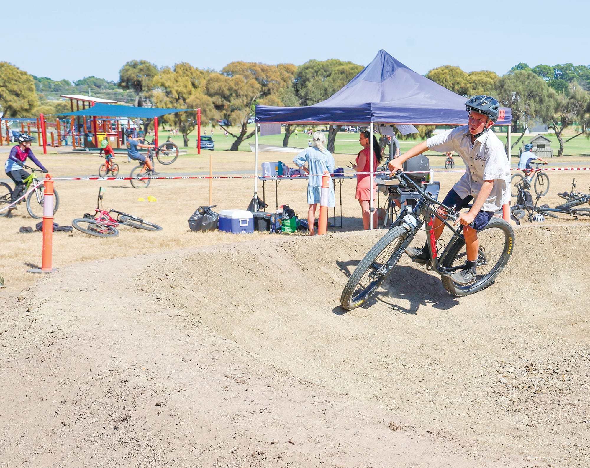 Part of the team of track builders, Ethan Tilley, tries out one of the new berms in the mountain bike course on campus at Newhaven College which includes a forest section.