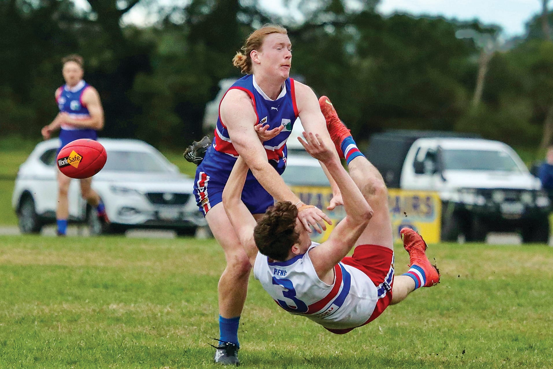 A brutal tackle after the boot for Phillip Island’s Jordy Patullo. Photo: Carol Ratcliff.