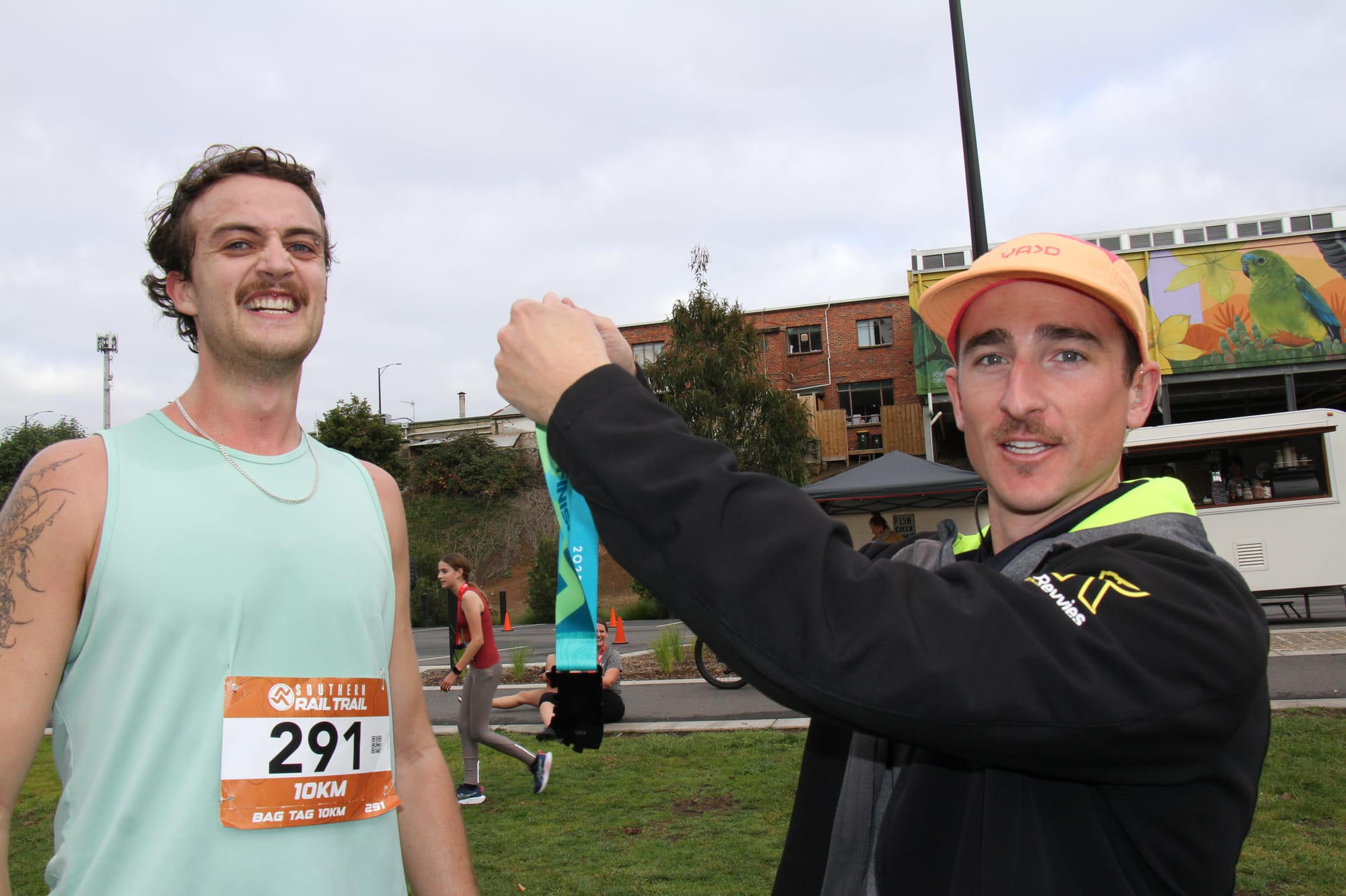 Marcus Hope 10km winner 2025 Southern Rail Trail Run (36.30) received his race medal from event organiser Kyle Anderson. B89_2225