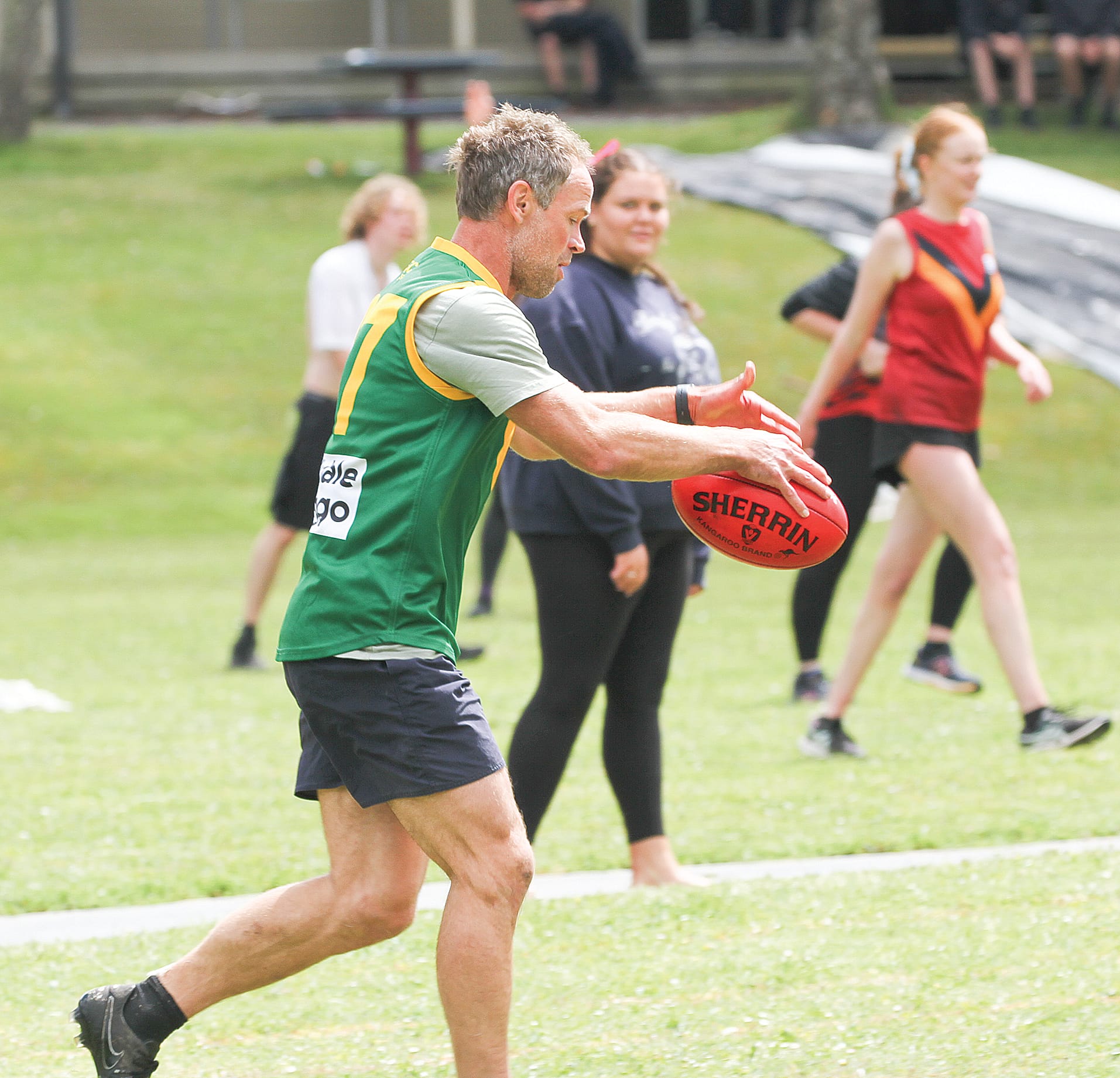 Foster Secondary College teacher plays on after taking a safe mark.
