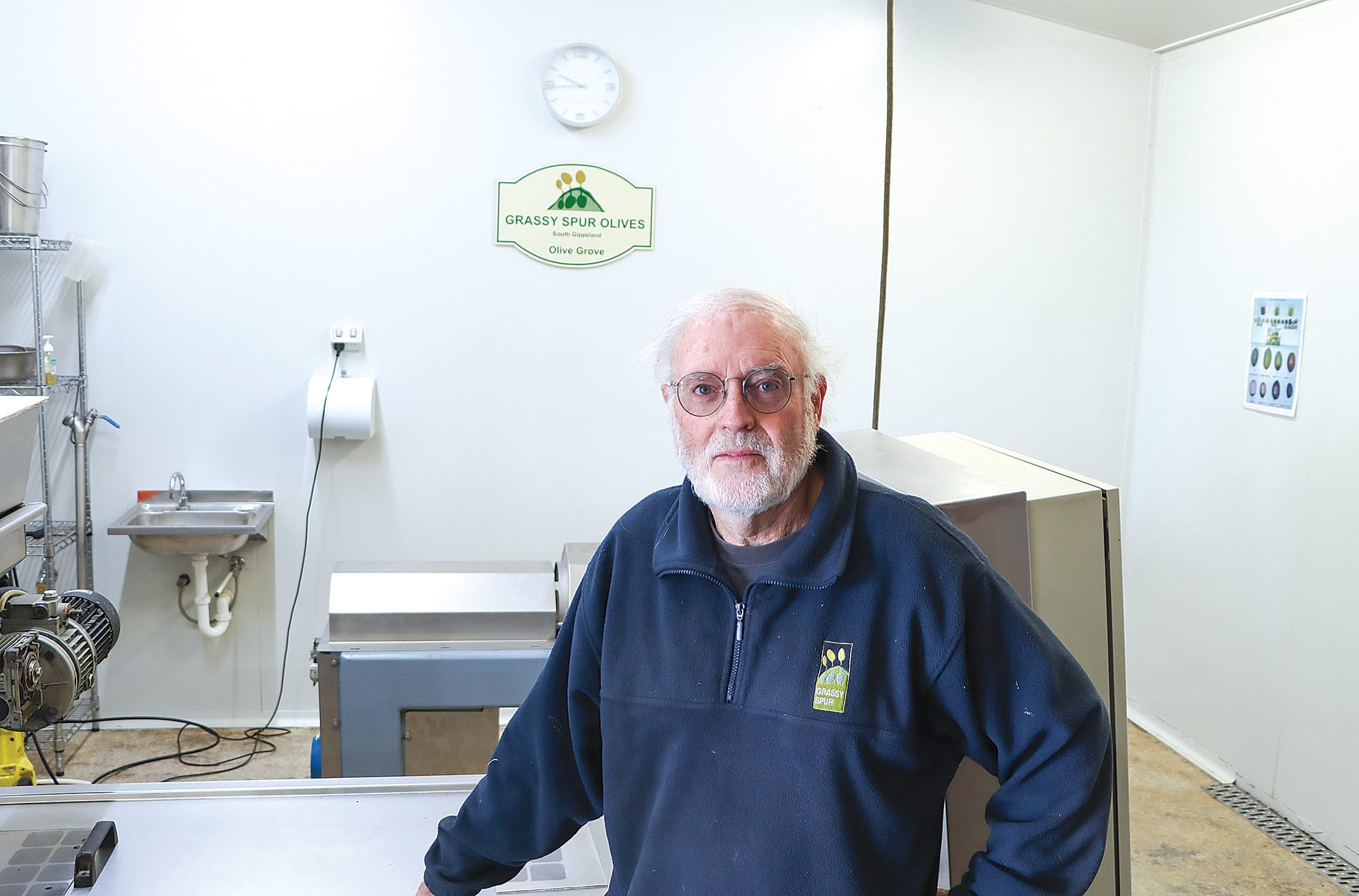Peter Wright stands in the olive processing room. A03_4524