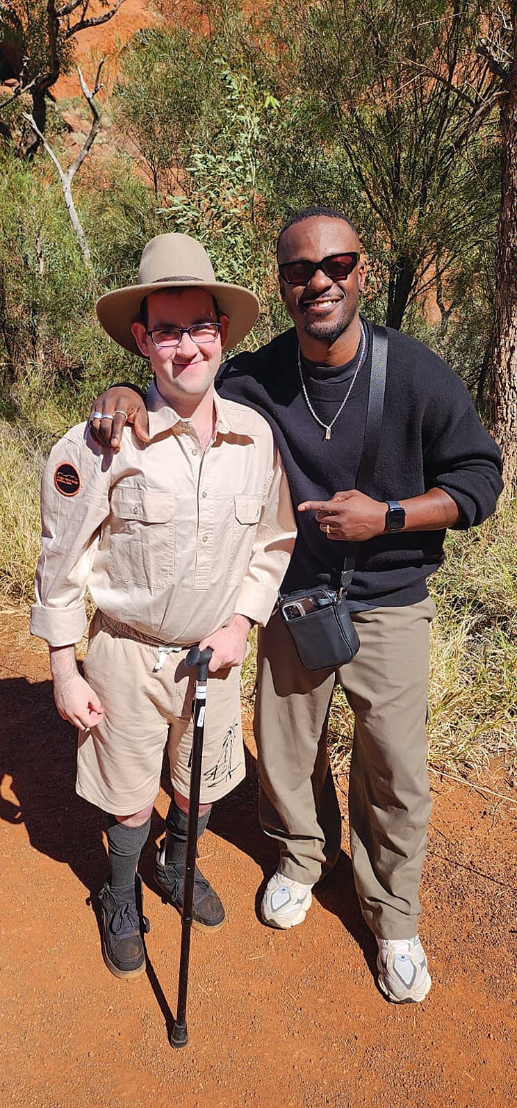 Wyatt, dressed in his special ranger shirt and Akubra after being presented with the gift, stands with Starlight Ambassador Timomatic.
