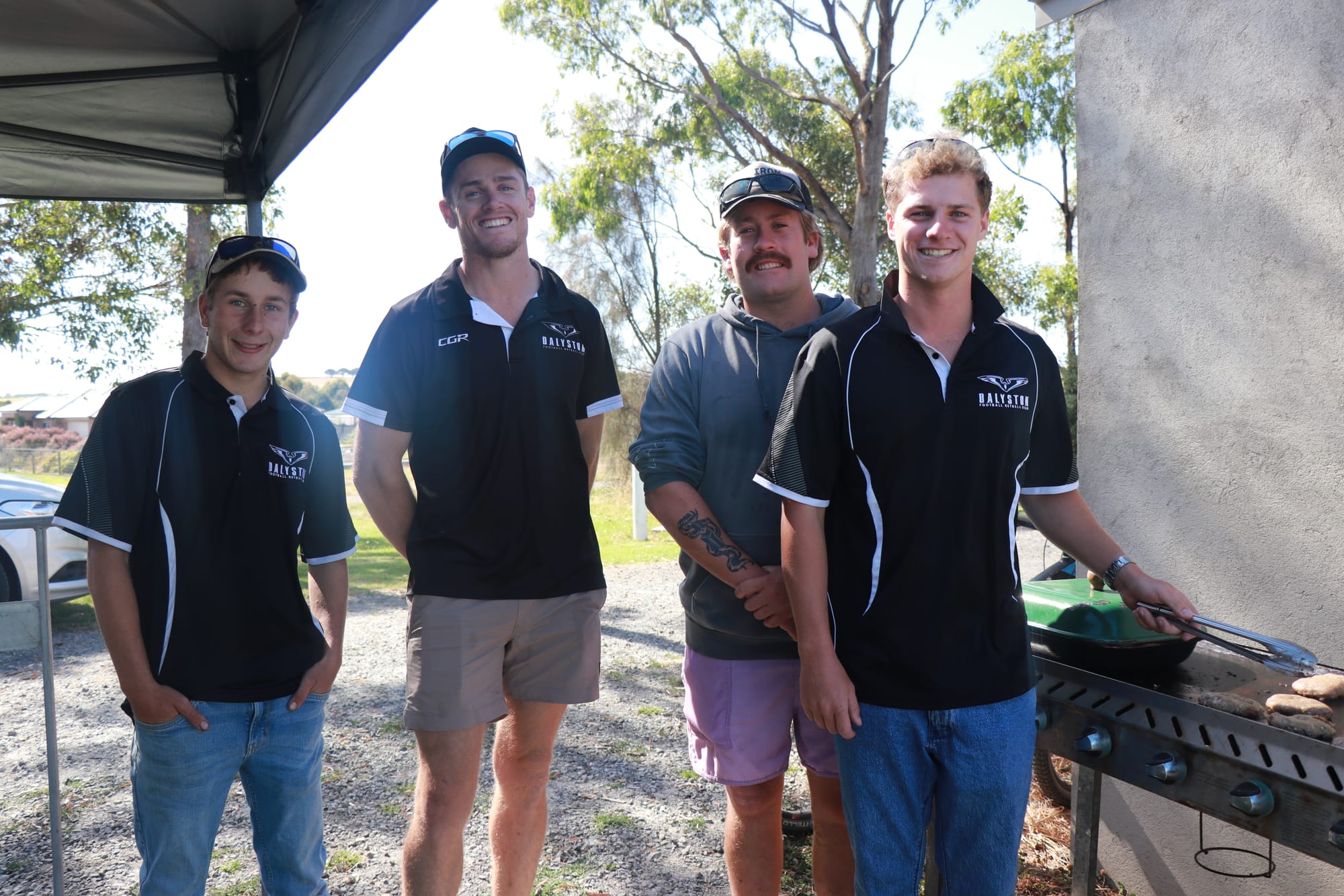 Dalyston Football Club members Leit Rivers, Michael Harris, Beau Van Veenendaal and Shay Davis cook up the sausage sizzle at the Oz Day at Daly this afternoon.