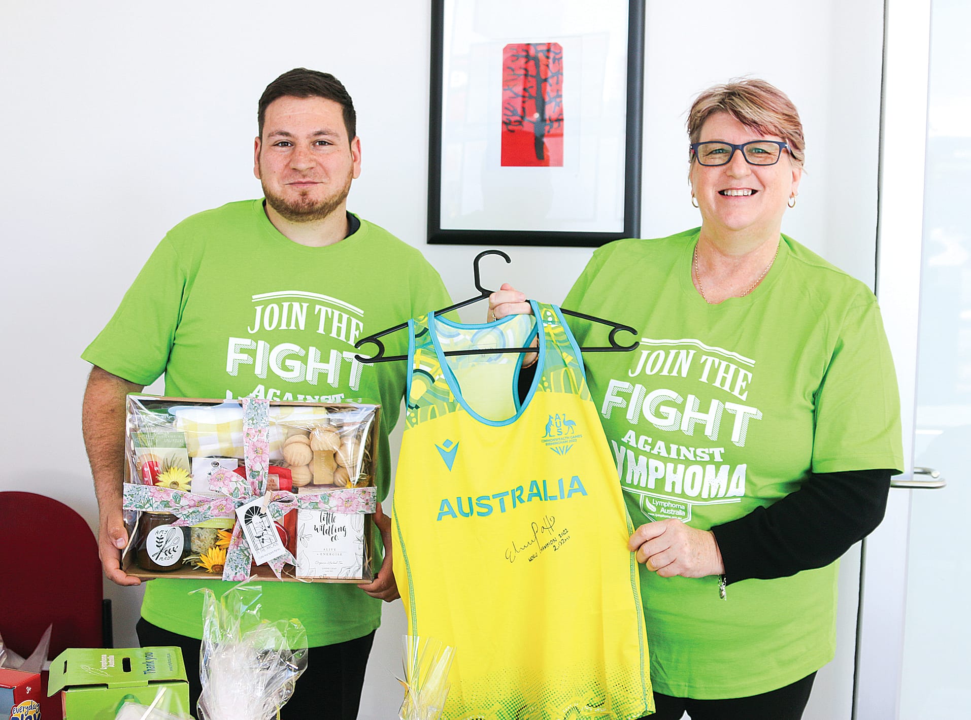 Jayson Filomeno and Kerry Zuidema of Alex Scott and Staff display donated items for the upcoming World Lymphoma Awareness Day morning tea in Leongatha.