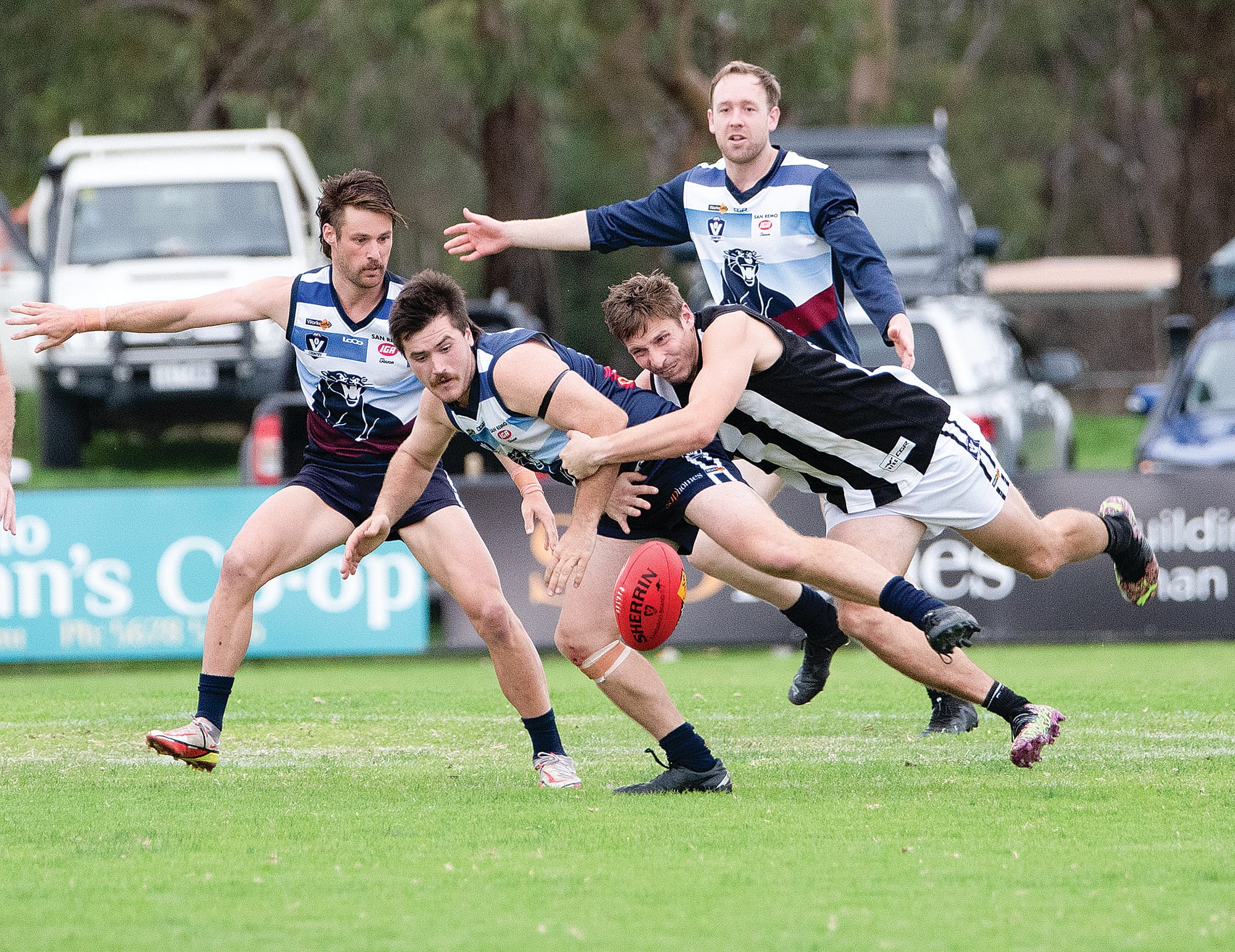 Lachlan Burns goes down as Dalyston swarms. 