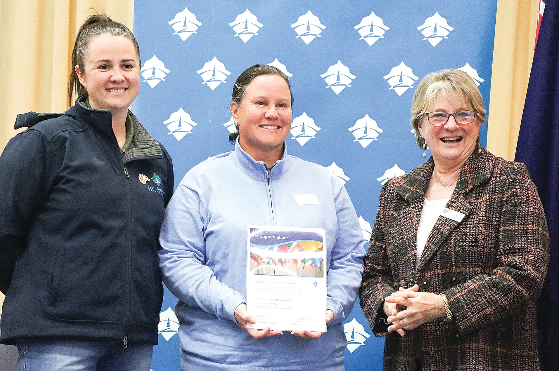 Dani Calafiore of Mirboo North Pony Club accepts $7500 to assist with a safe horse yards project, with Mayor Clare Williams and Cr Jenni Keerie. A08_3124