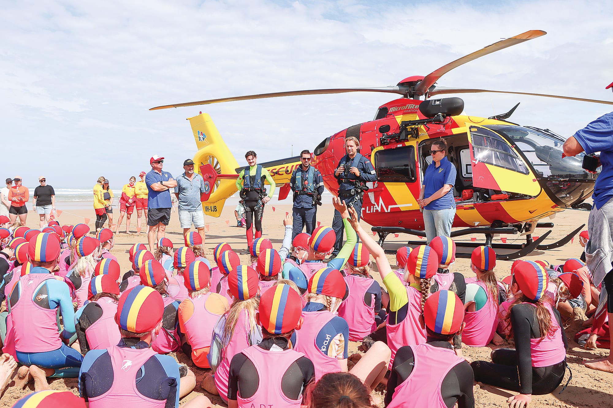 Nippers from Venus Bay Surf Life Saving Club are keen to ask questions of pilot Pete Nelson, and aircrewman Jack Slykhuis during the Westpac Rescue chopper visit. A03_0224