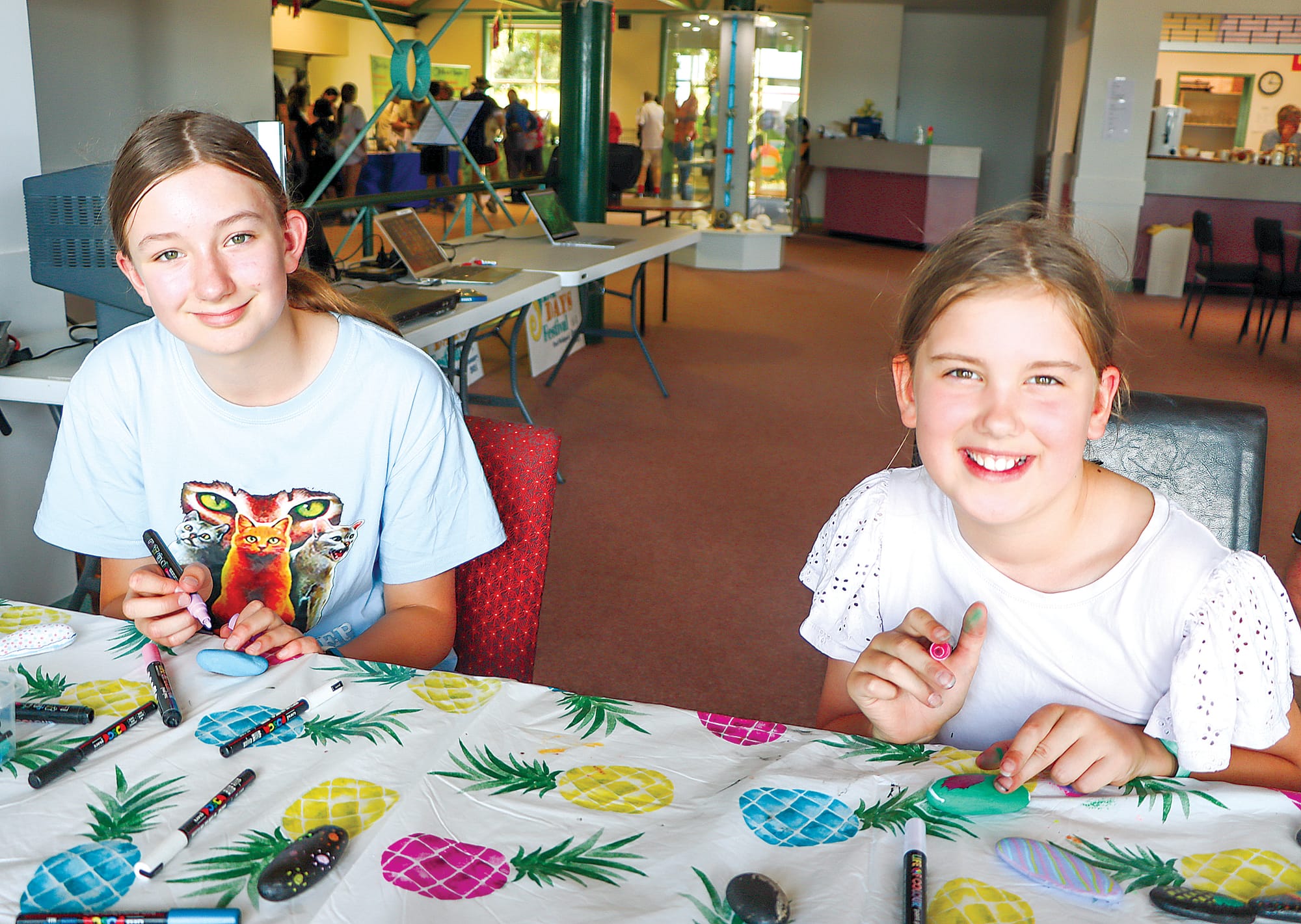 Lila and Elsie Robertson paint rocks and learn about upcoming Myli Library sessions. A33_0224