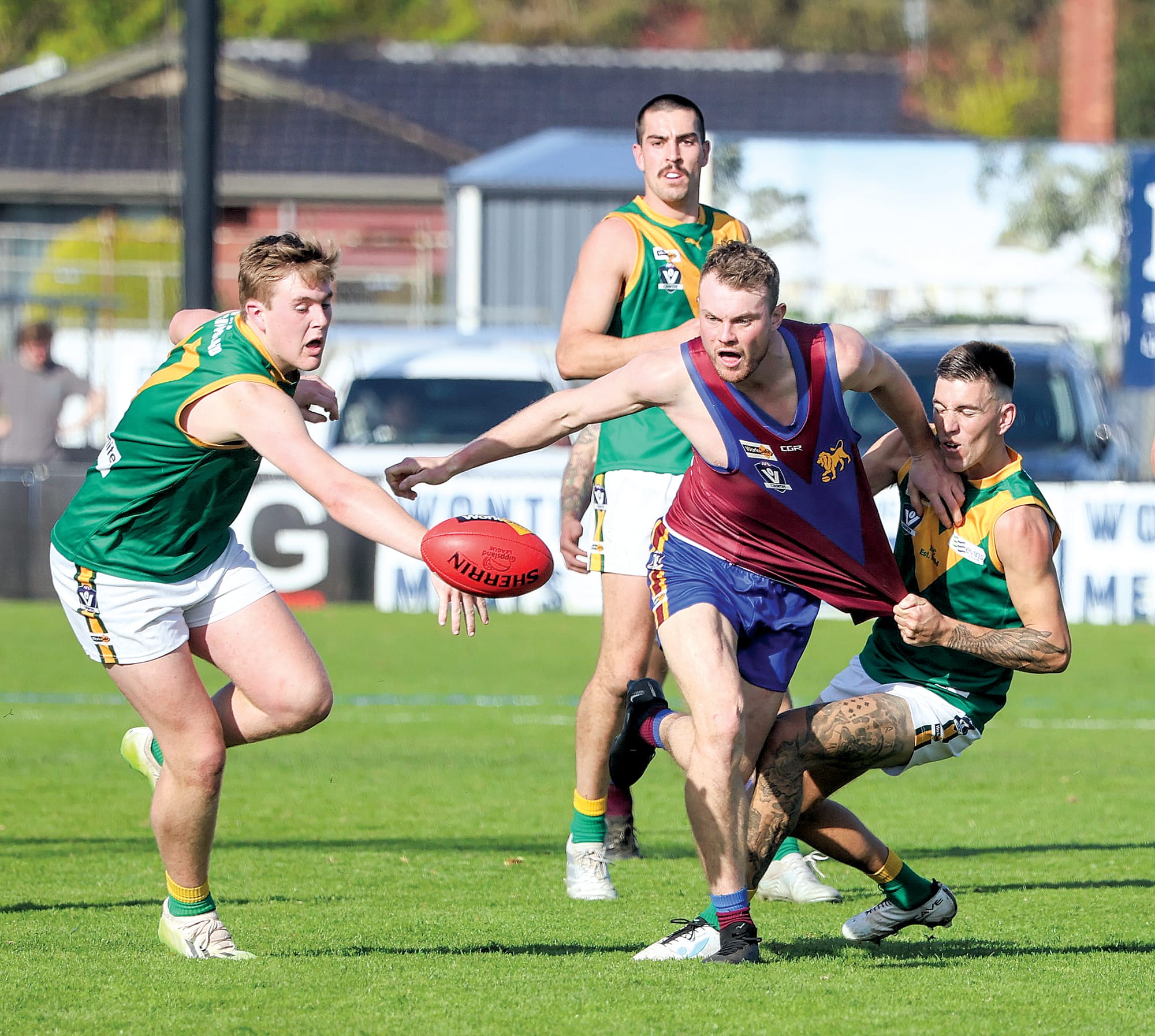Leongatha’s Josh Hopkins lends a hand as Jenson Garnham looks to take possession after this stoppage.