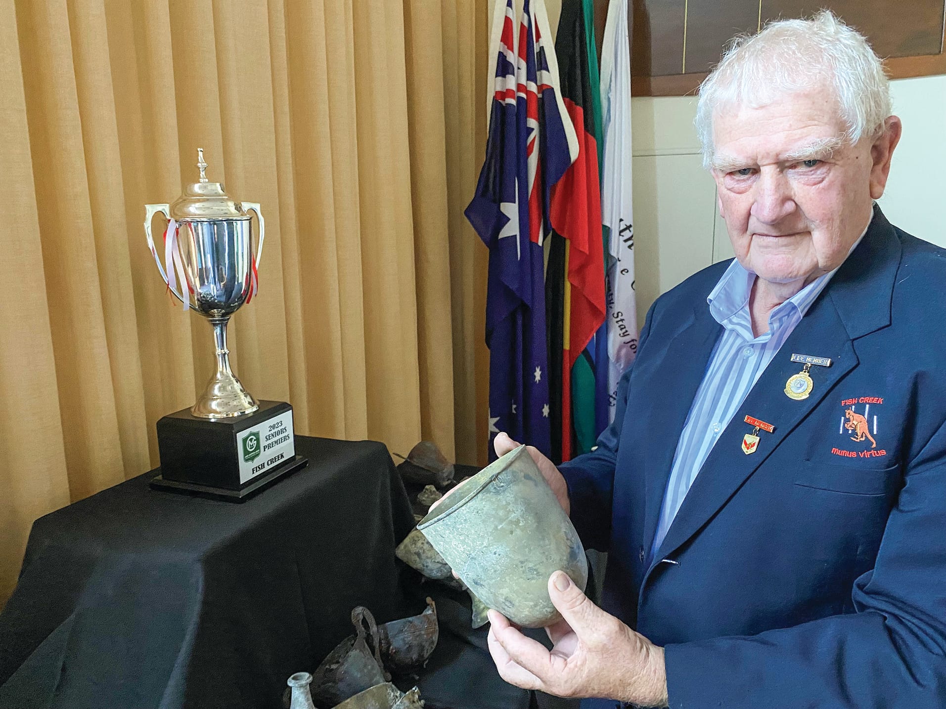 Fish Creek FNC life member and former president (1991, 92, 93) Lou Seuren can just make out the date on one of the senior premierships cups won during his time, but destroyed in last November’s fire.