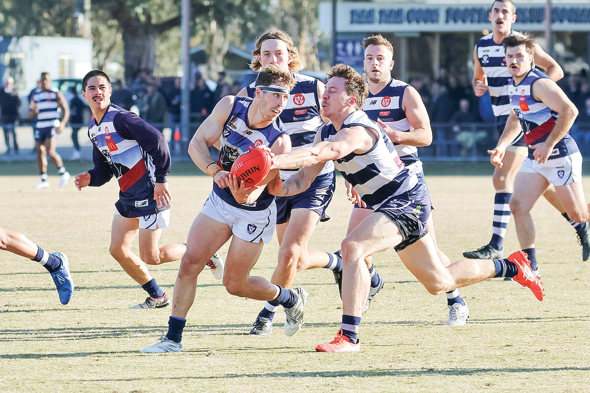 Panthers’ Nathan Foote handballs under duress. Photos: Kylie Pipicelli, Nar Nar Goon Football Club