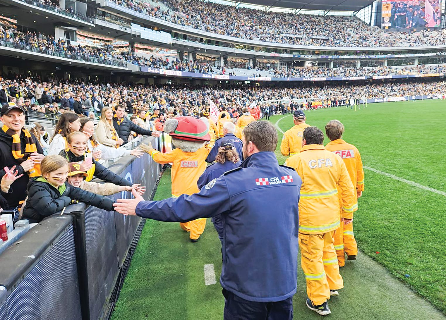 Hawks and Tigers fans giving local CFA volunteers a big MCG welcome.