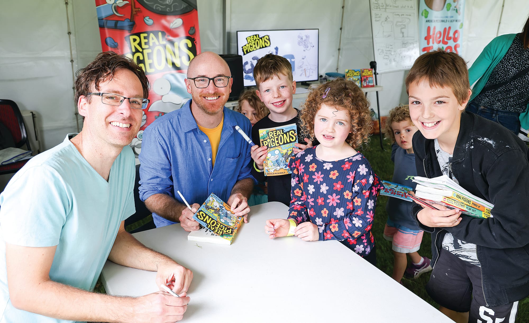 Children’s author and Illustrator Andrew McDonald and Ben Wood sign autographs for young admirers including Francis, Greta and Leo. 