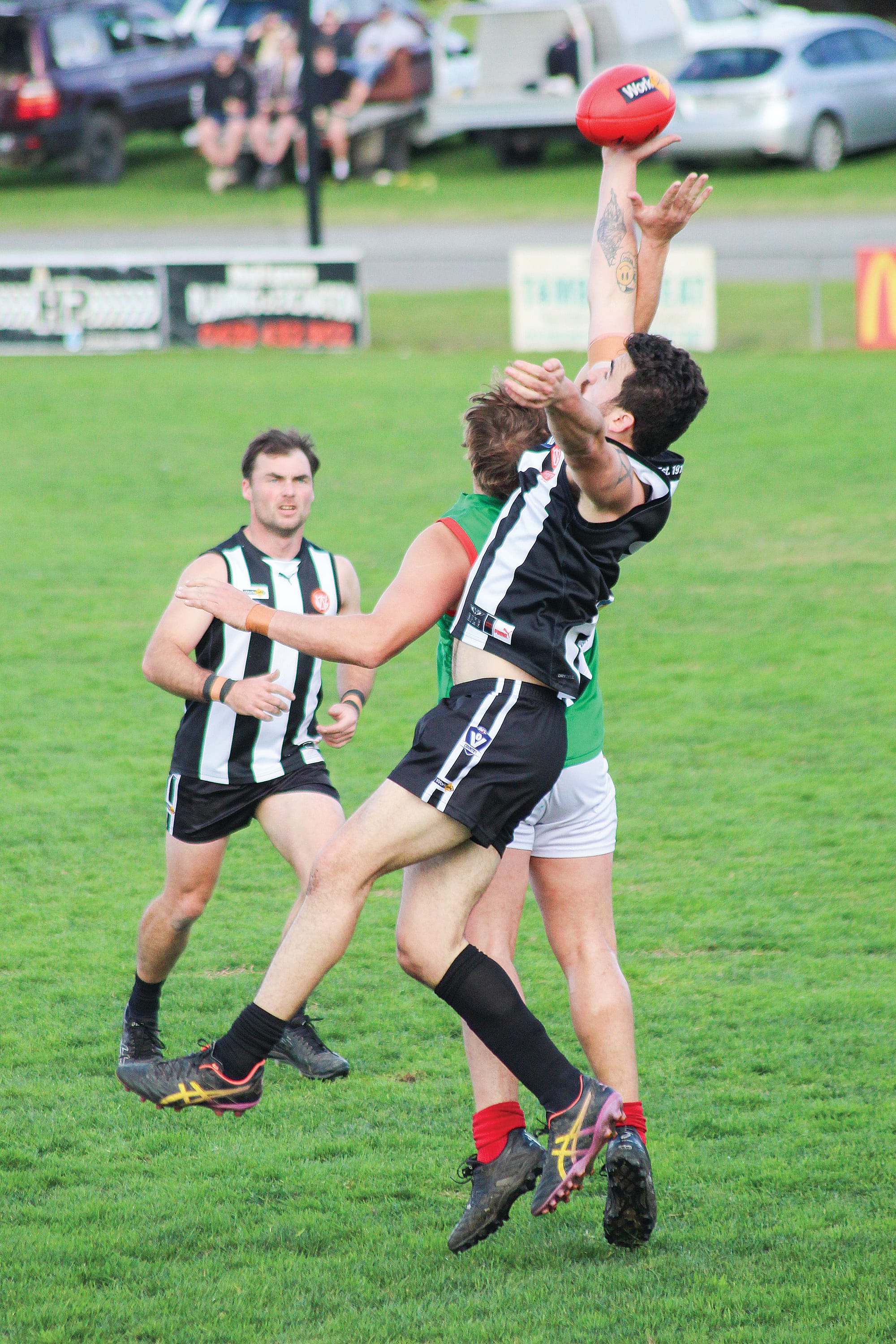 Dalyston Jack McMally out paces his Tooradin-Dalmore opponent, supported by Kurt Thomas.
