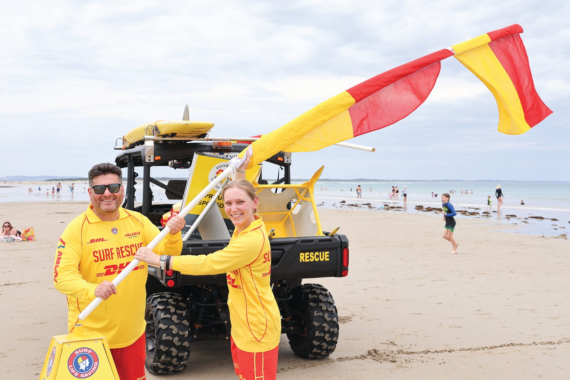 Erecting the flags ahead of the first volunteer patrol at Inverloch Surf Beach on Saturday were surf lifesaving club members Sam Dimopoulos and Lucy Tate in a sure sign that summer is here. But a coalition of local community groups fears problems are looming without immediate action at Inverloch.