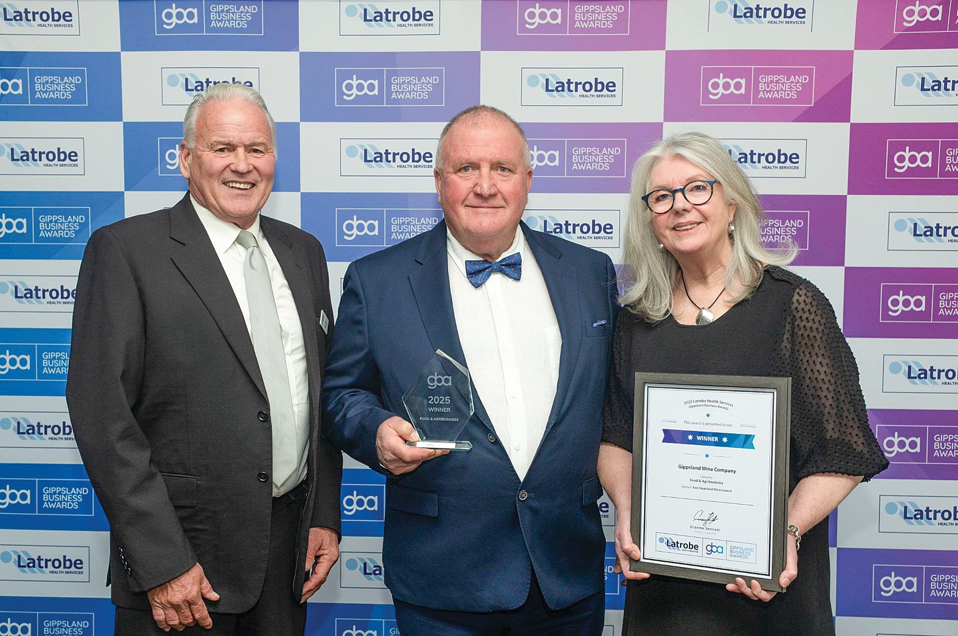 John White from East Gippsland Shire Council (left) is pictured presenting Mark Heath and Jane Taylor from the Gippsland Wine Company with their award in the Food and Agri Business section.