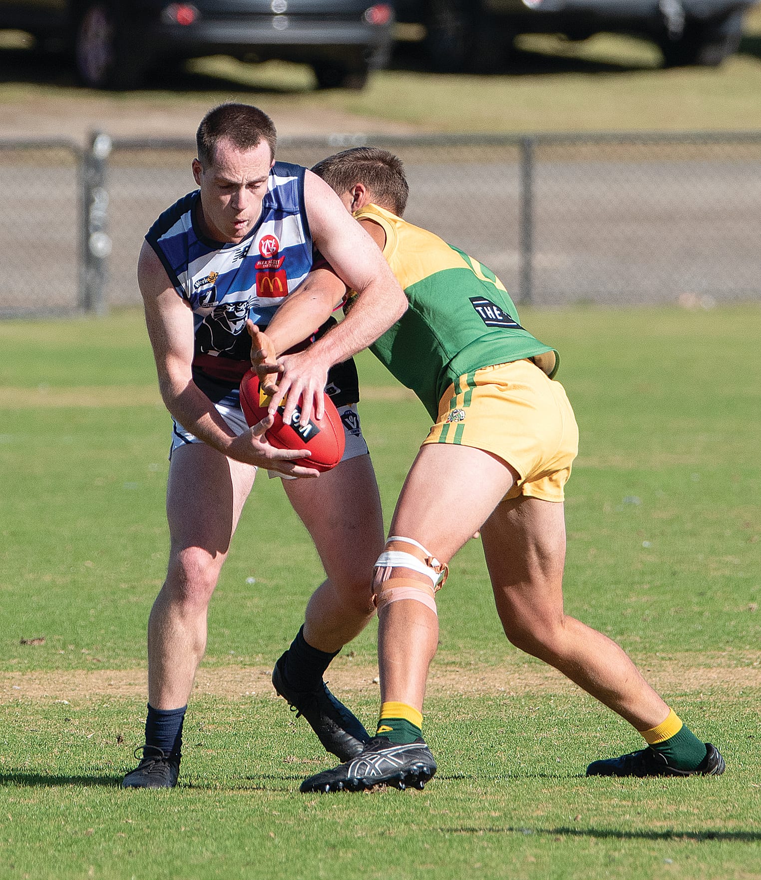 #47 attempts to control the football while tangled up with his Garfield opponent in the Reserves match.