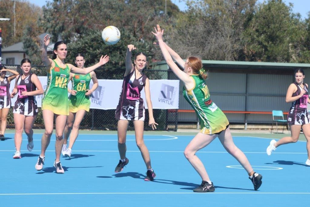 Leongatha Under 17 netballers Sari Hickey and Lara Gill try to block the progress of Sale's Jasmine Stewart in a see-sawing Qualifying Final that ultimately went Sale's way.
