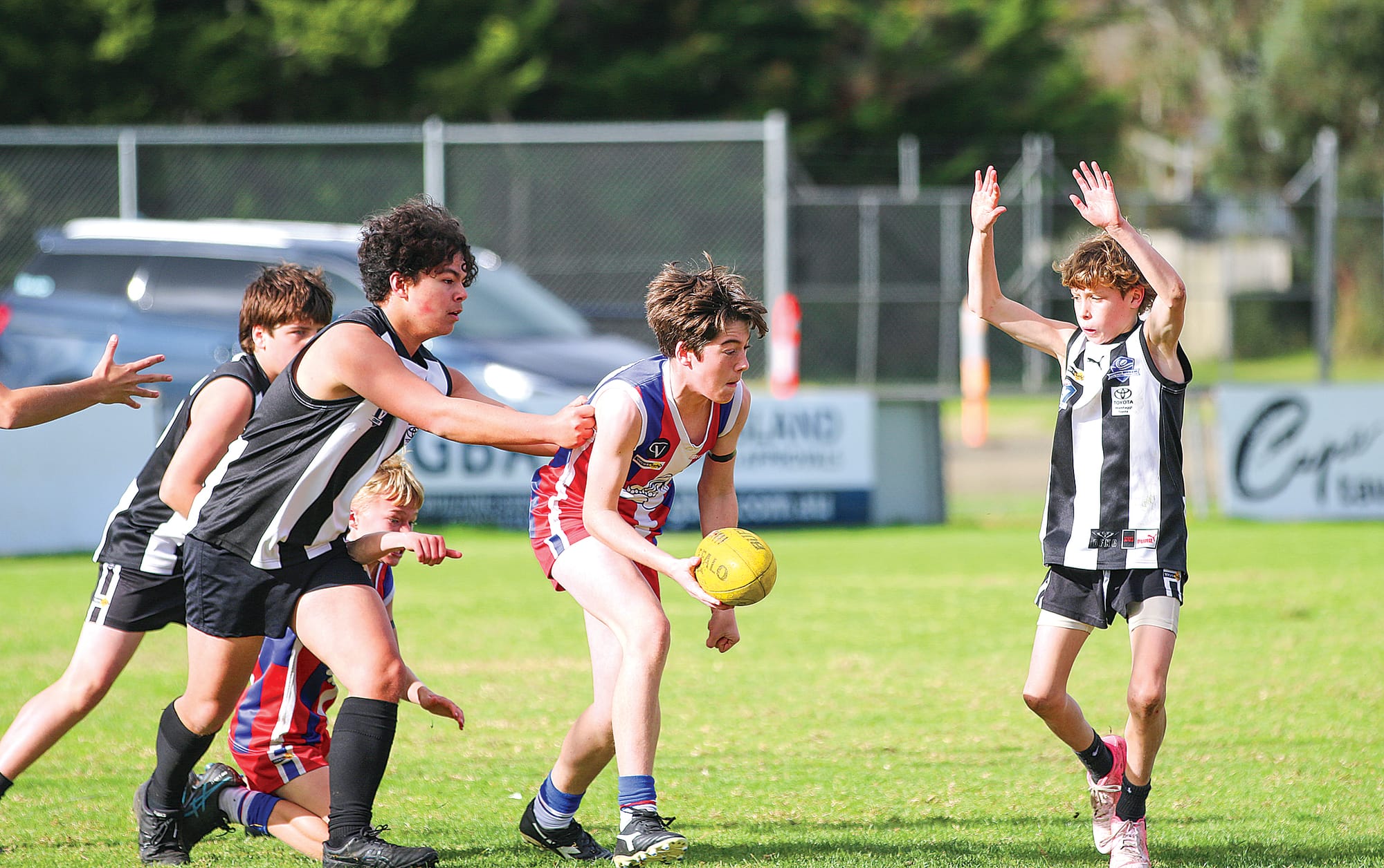 Phillip Island’s Zac Basterfield takes possession of the ball and fights to get it out of Dalyston’s forward line.