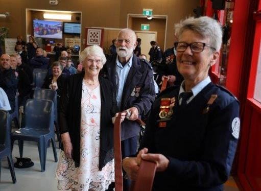Life members including Sue Waterton and June Murdoch unroll the hose to mark the opening of the new Phillip Island Fire Station.