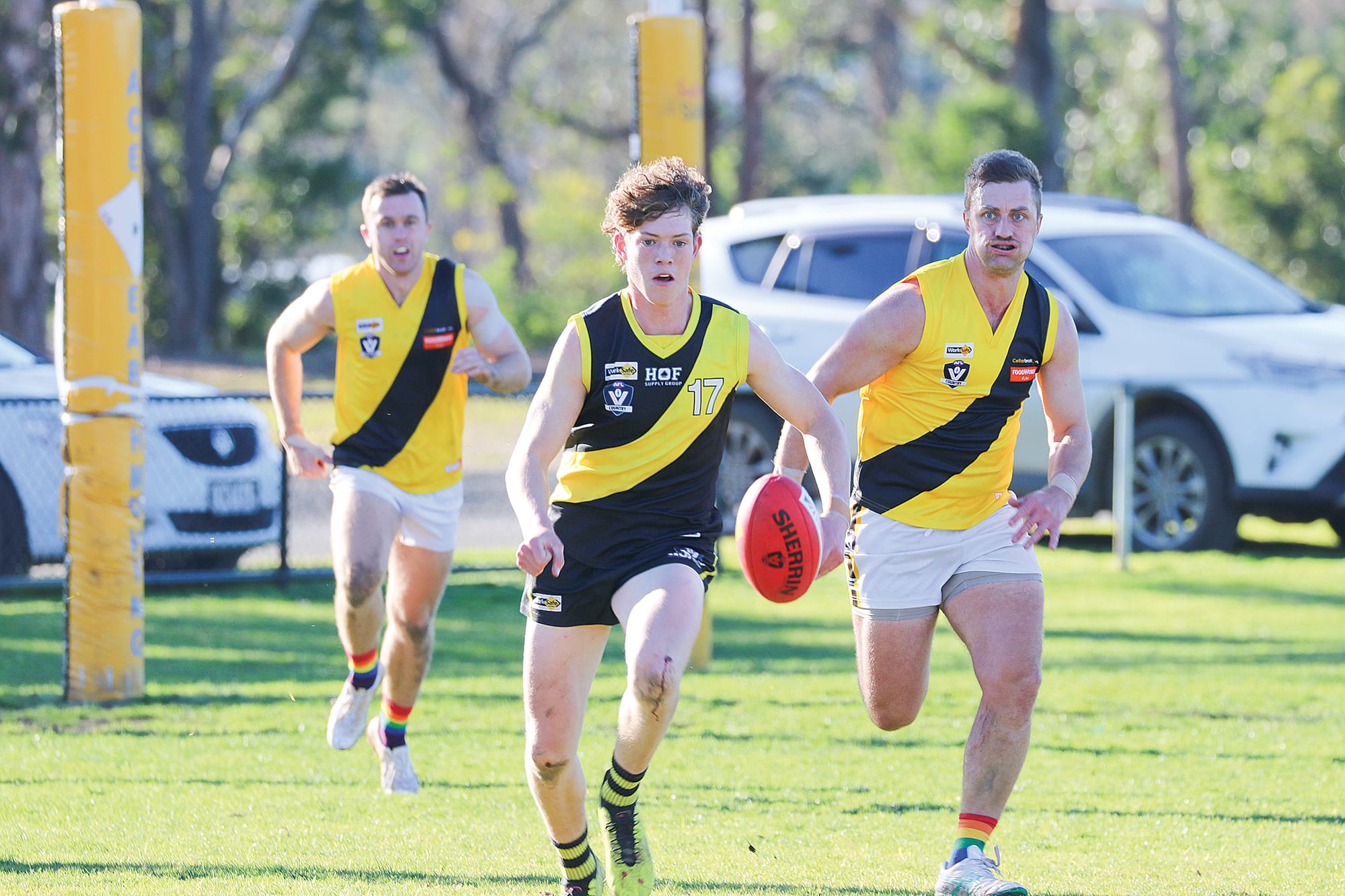 The chase was on as Mirboo North’s Jonathan Conlan beats Foster’s James Morris to the Sherrin. 