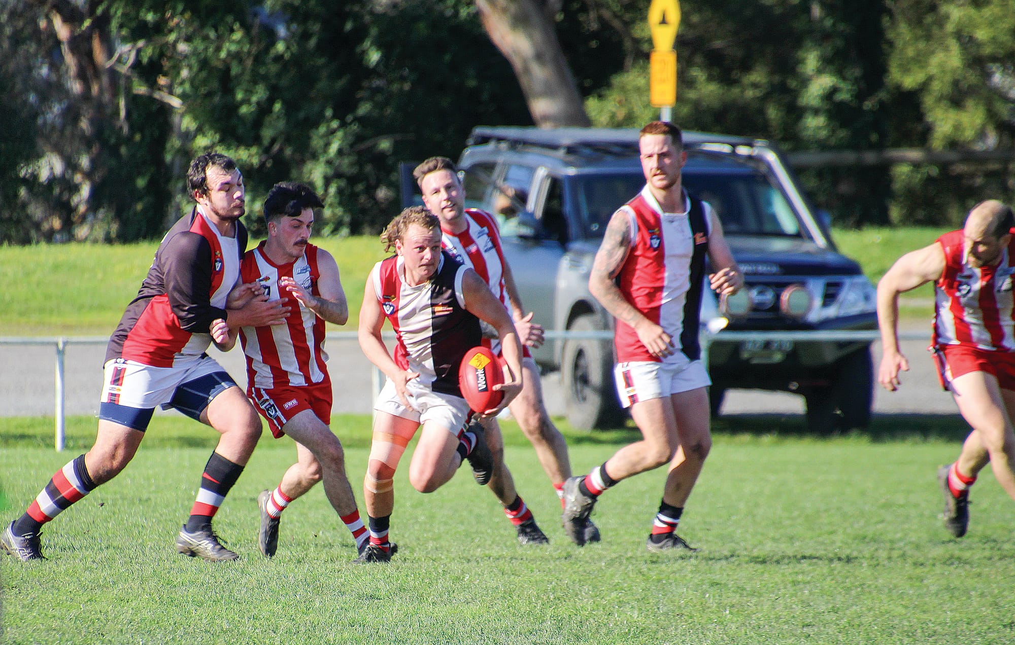 Nyora’s Lucas Lee scoots out of danger to send the ball forward for his team.