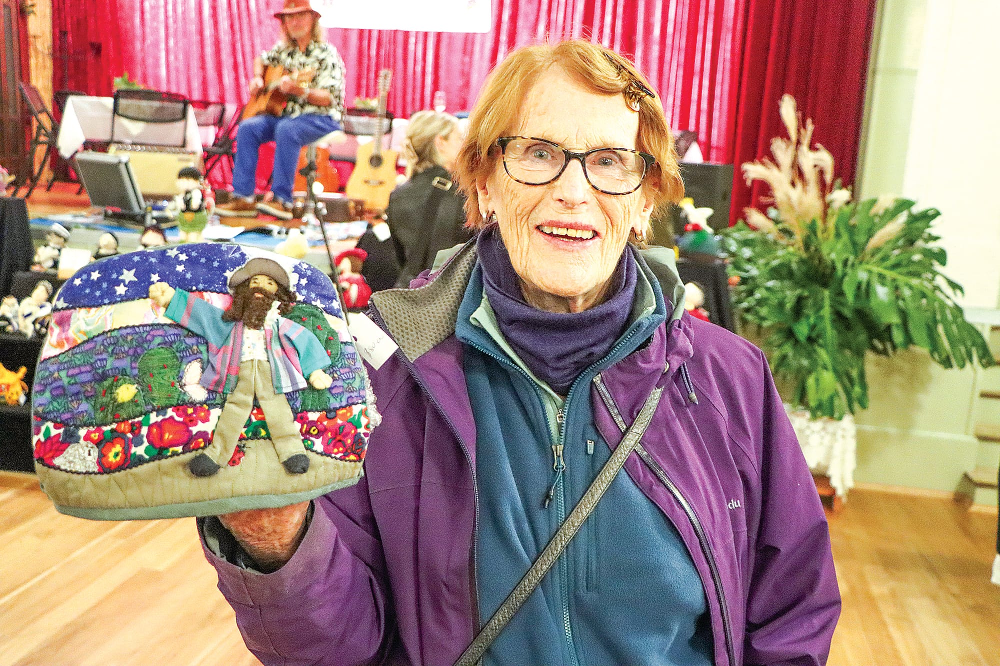 Lynne Carlin who travelled from Western Australia to be part of the Fish Creek Tea Cosy Festival holds one of her entries depicting TV gardener Costa Georgiadis. A14_2124