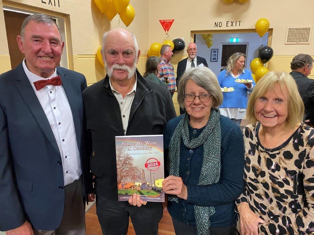 MC at the Poowong 150th celebrations Russell Motton joins Greg Barry, Lyn Mitchard and Pam Williams in getting their copy of the new Poowong history book.