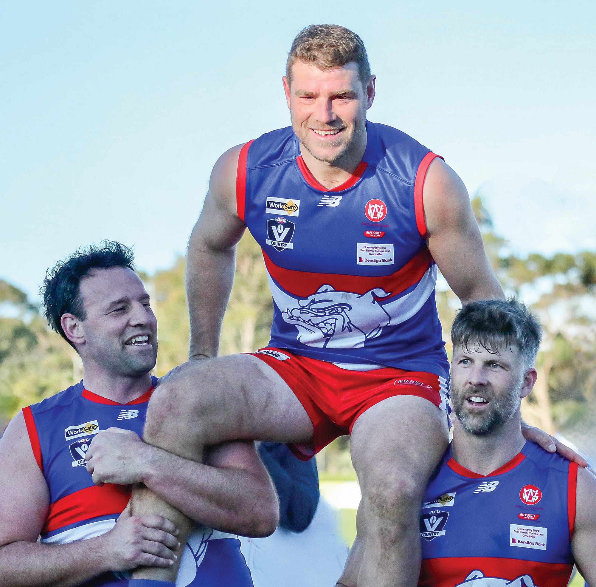 Team mates Cam Pedersen and Jaymie Youle help celebrate Mark Griffin’s 200th game. Photo: Carol Ratcliff