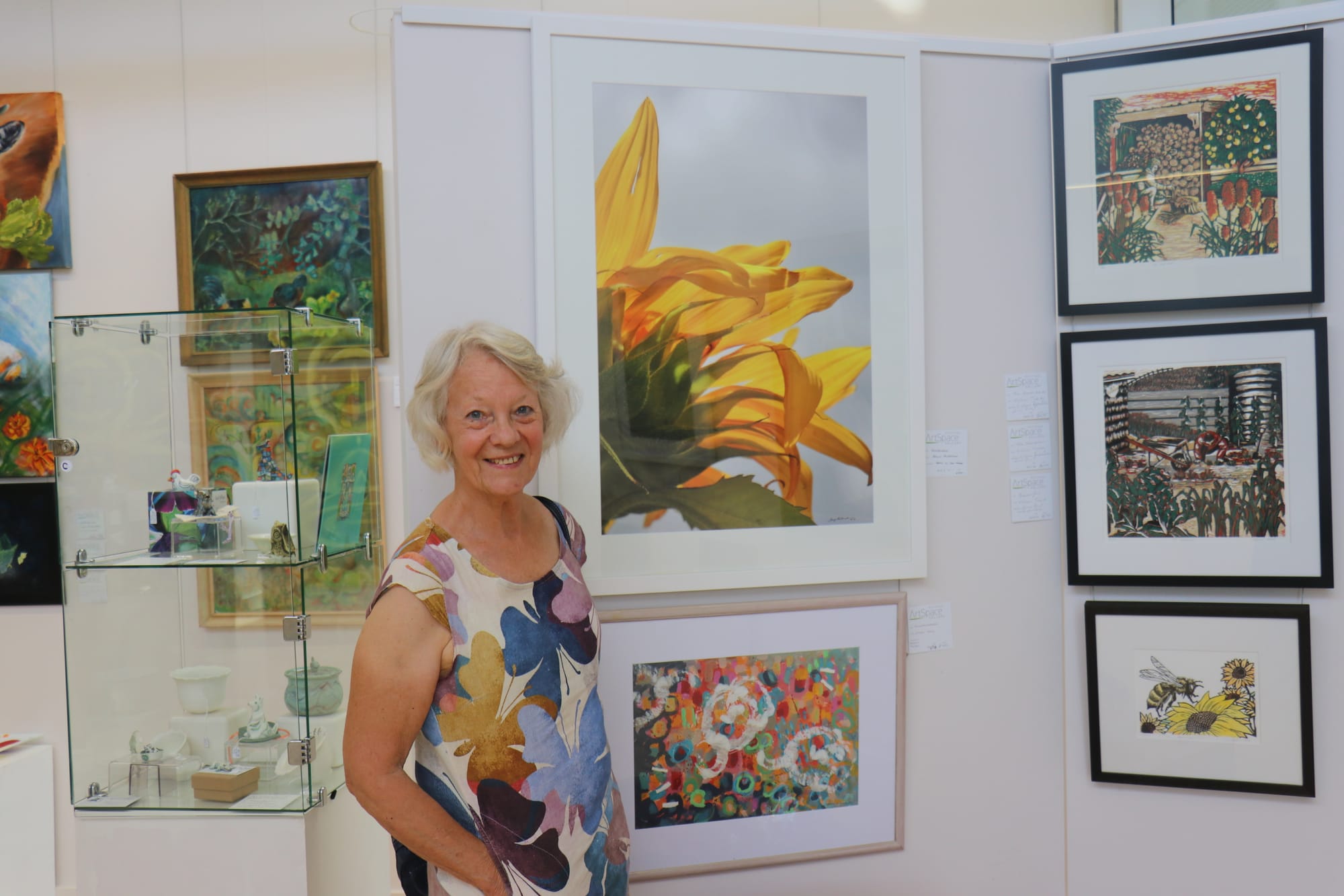 Artist Jenny McDonald exhibiting ‘Sunflower’ photo on art paper.
