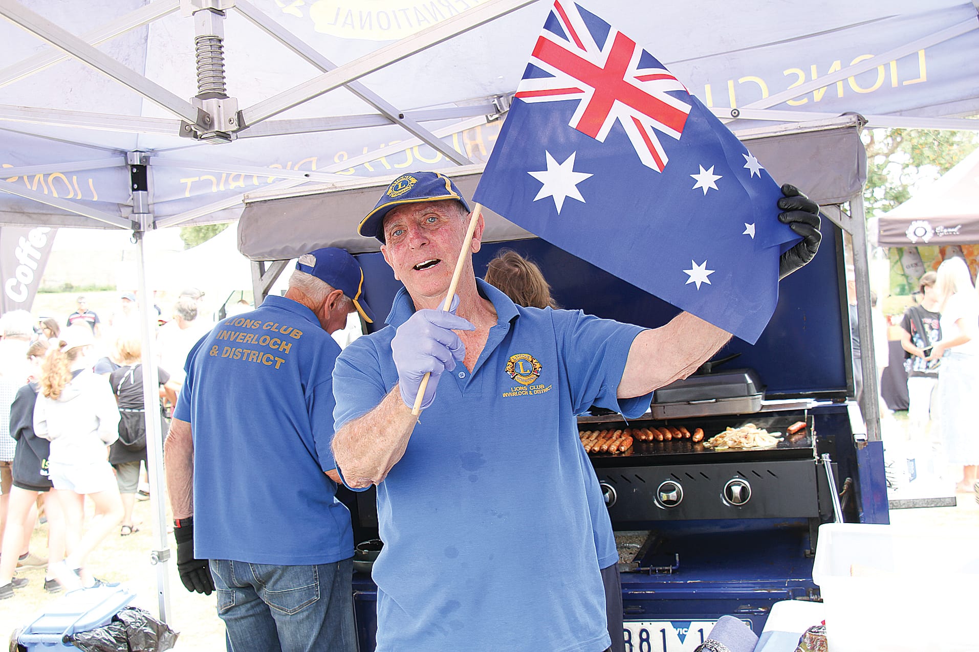 Former President of Woorayl Shire and 25-year member of Inverloch Lions Terry Hall cooks sausages for Australia Day at The Glade. B19_0425