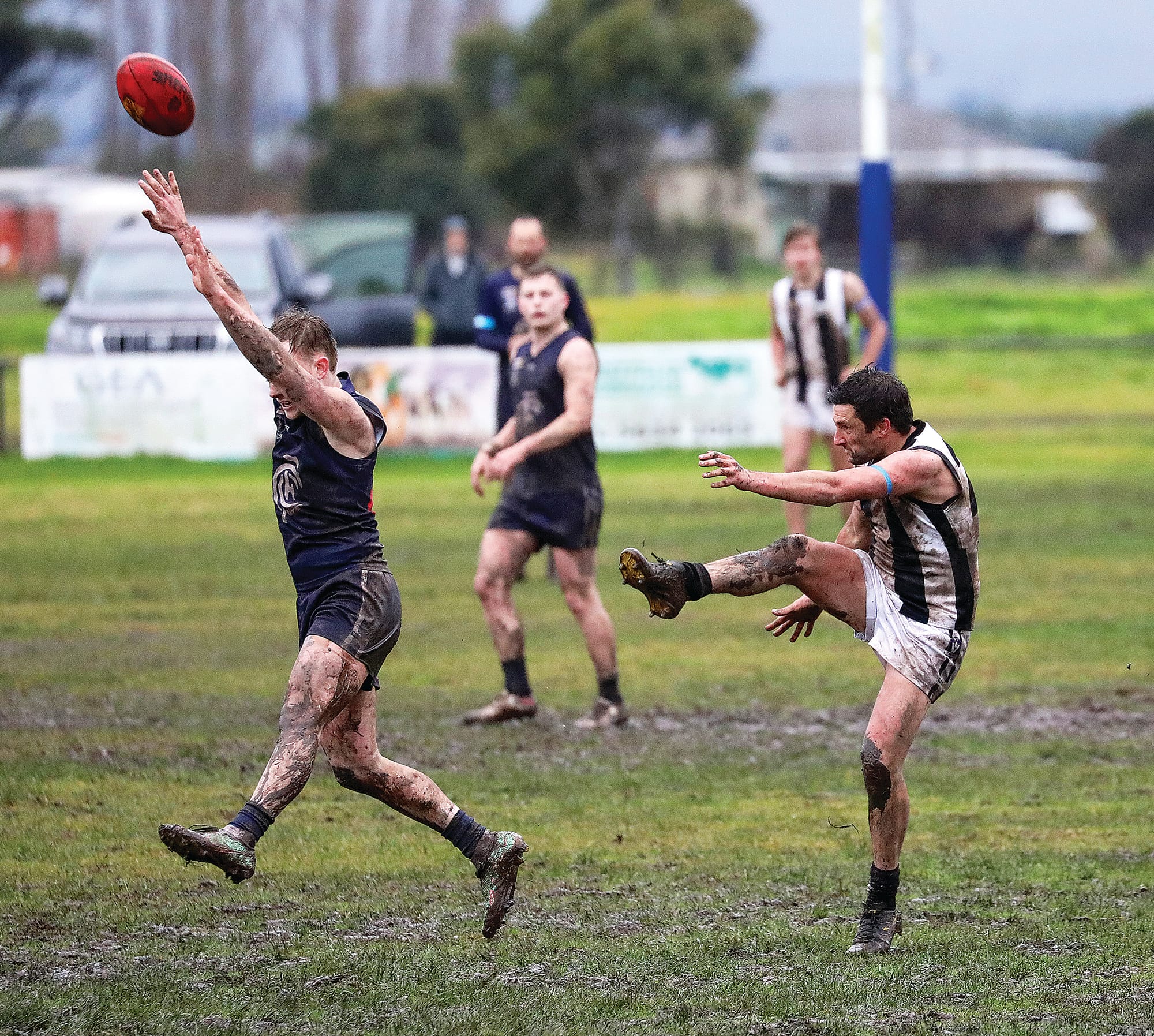 Poowong’s Matt Cozzio (Seniors) boots the Sherrin in Saturday’s slush. Photo: Jeff Tull. 