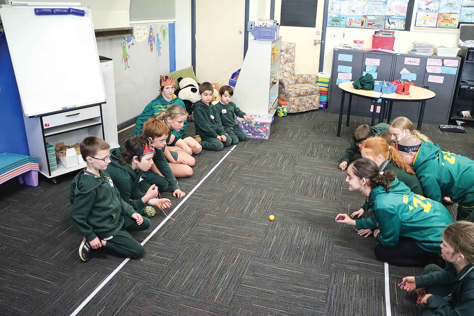 Students aim for a target, having learned about spear practice. A12_3024