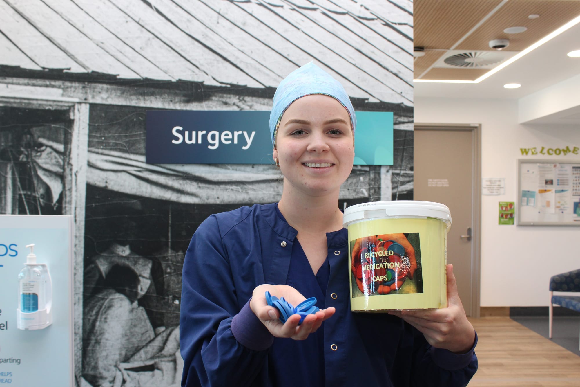 Clinical Nurse Specialist Jessica Kitson with a collection bucket for the recycling of medication caps.
