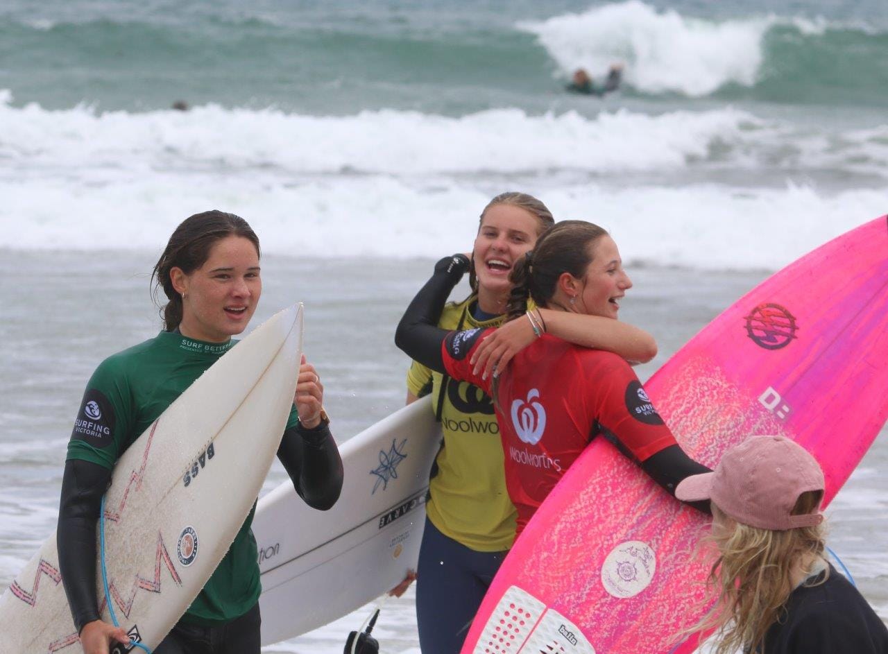 From left, third Sophie Thompson (green), second Eva Bassed (red) and the winner of Round 1 the Under 18 Girls final of the Woolworths Victorian Junior Surfing Titles Sarsha Pancic congratulate each other after a weekend of competition.