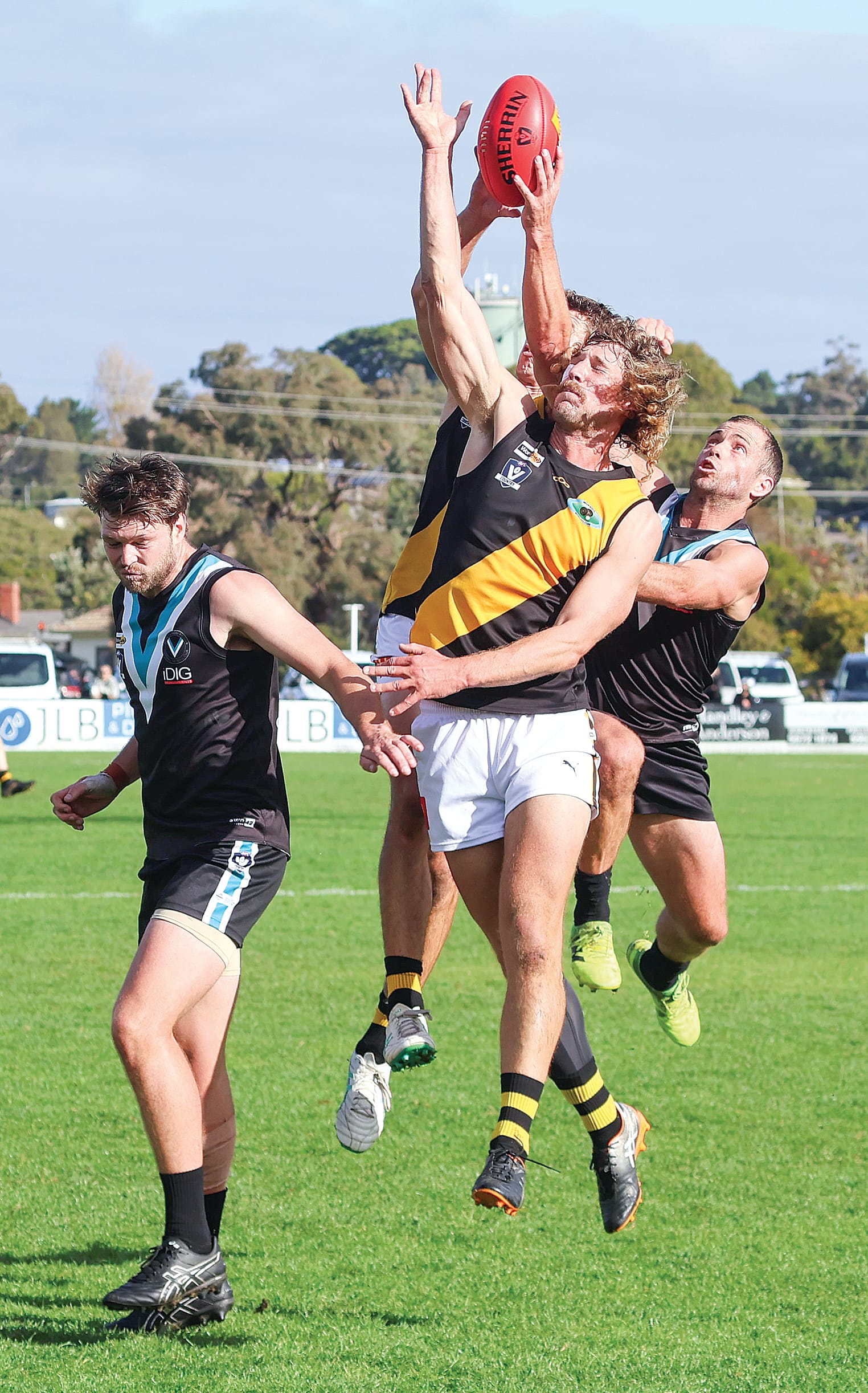 Back in for his first game of the season, Power coach Jarryd Blair flies with the big men trying to affect the spoil without much luck.