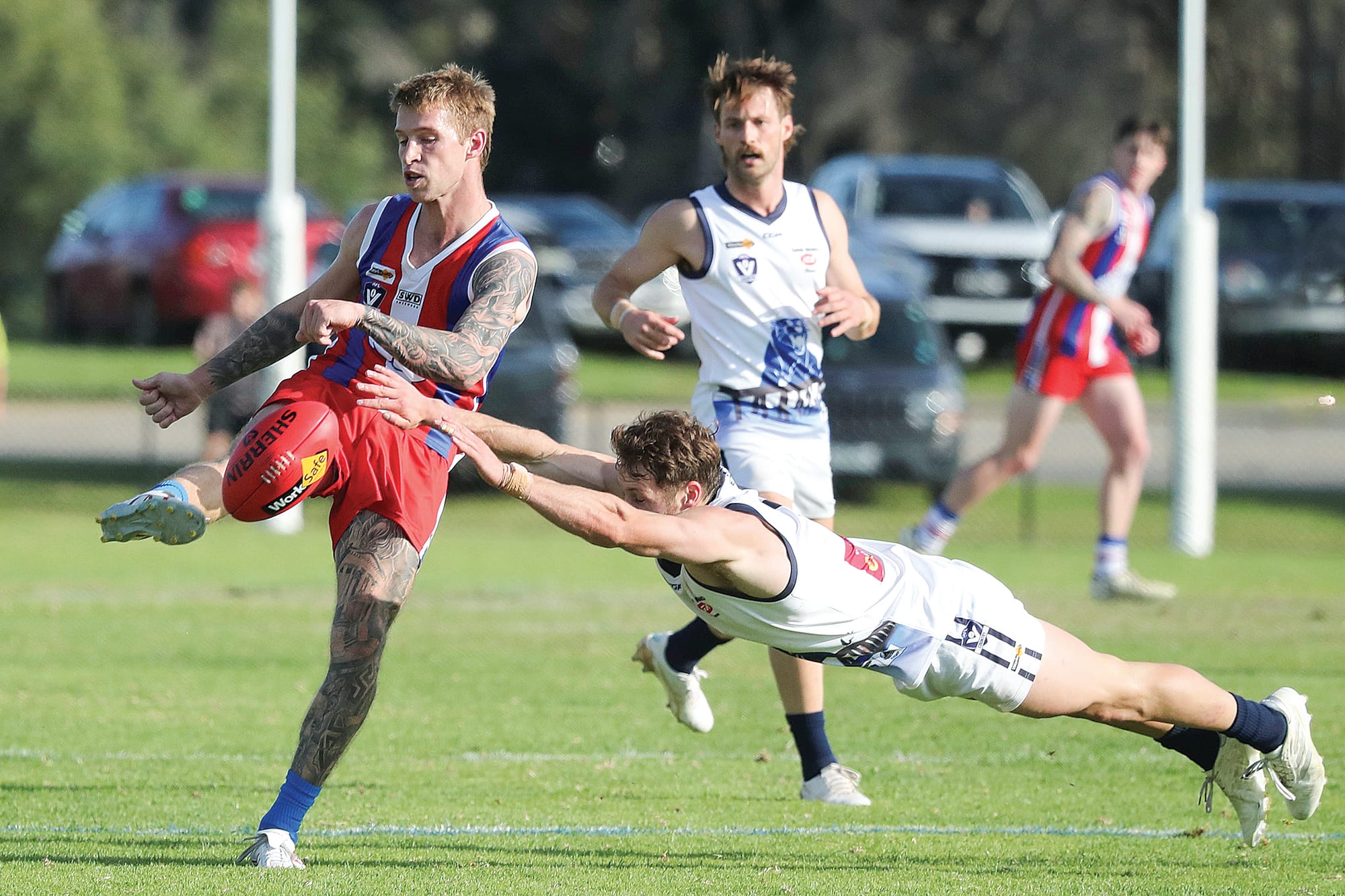 Bryce Hindhaugh puts boot to ball as a flying Nathan Foote attempts to smother. Photo: Carol Ratcliffe.