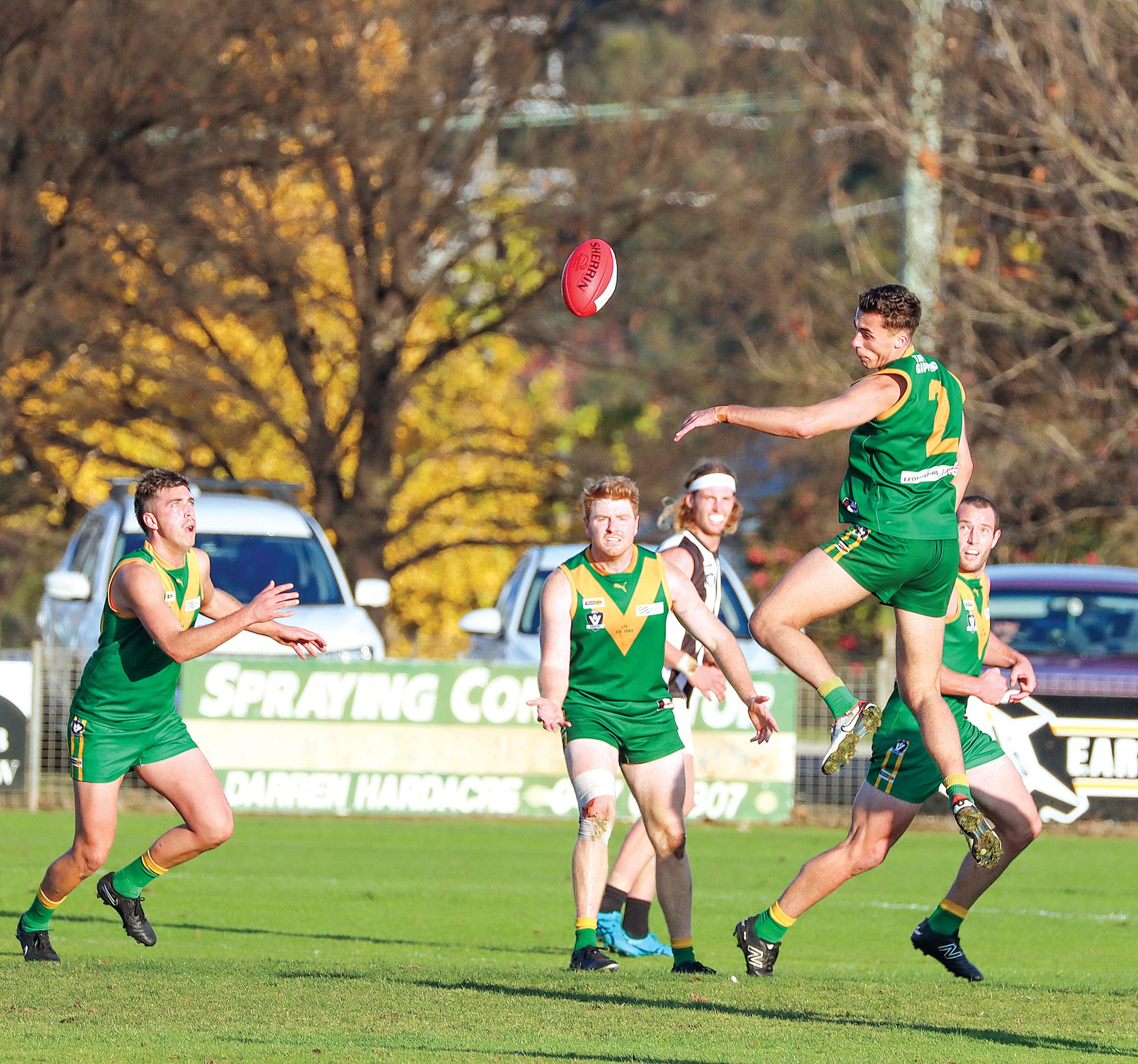 Jake van der Pligt takes off for Leongatha while a teammate looks to capitalise.