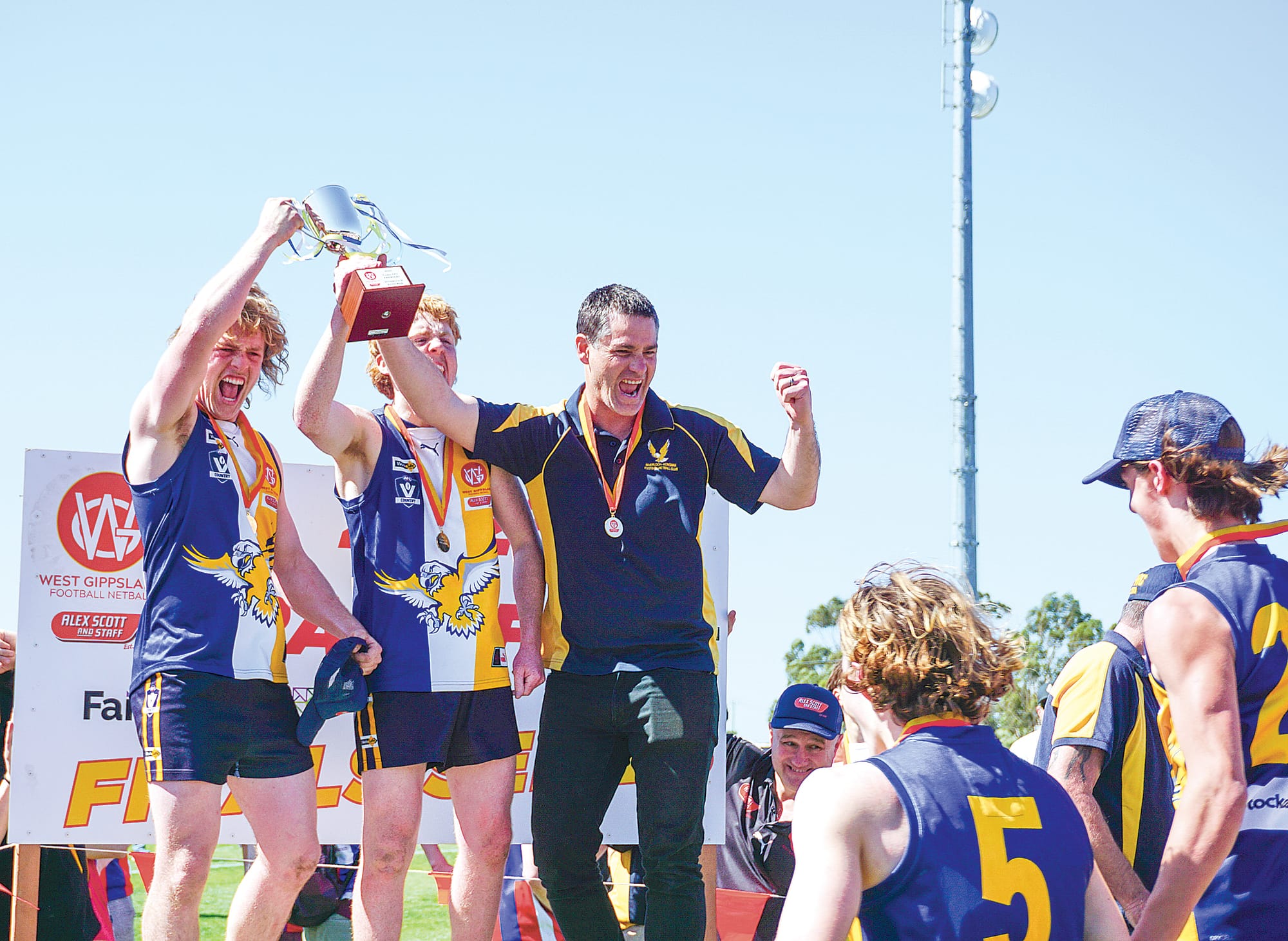 The trophy is held high by Inverloch’s under 18s. Ns103823