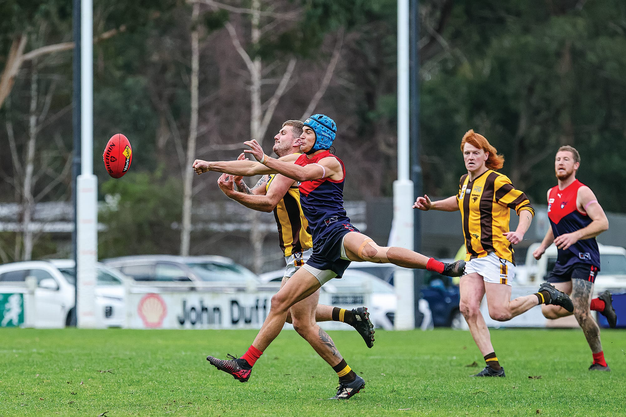 Brayden Sellings nudges his Hawks opponent in a vie for the ball. Photo: Bec Casey Sports Photography.