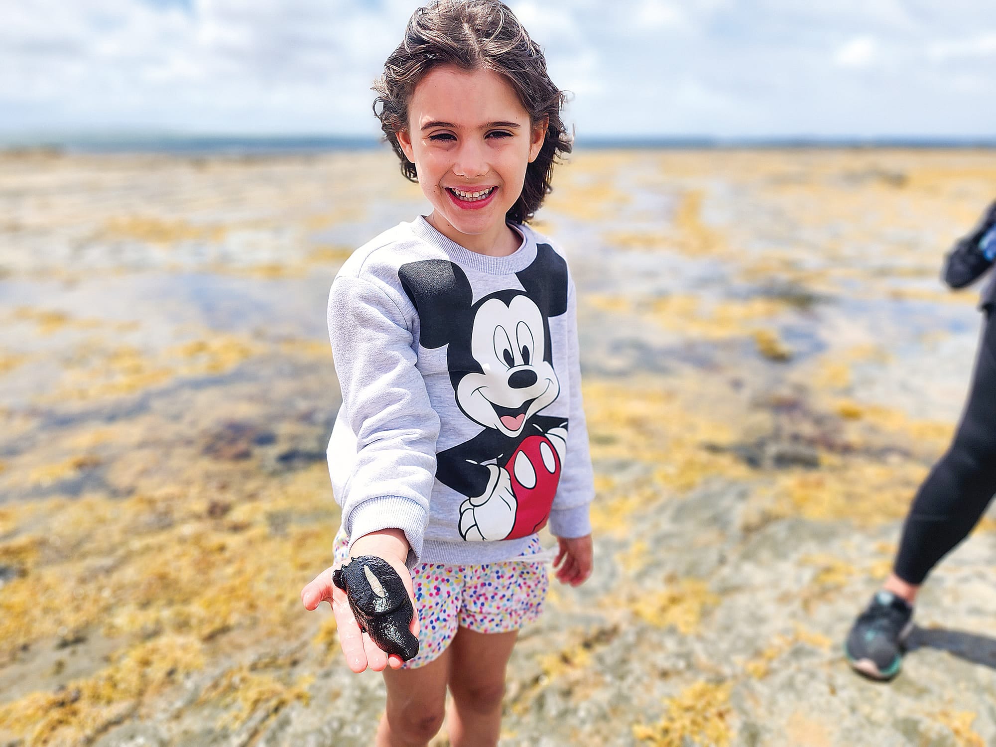 Maribel holds an elephant snail on Thursday. C24_0424