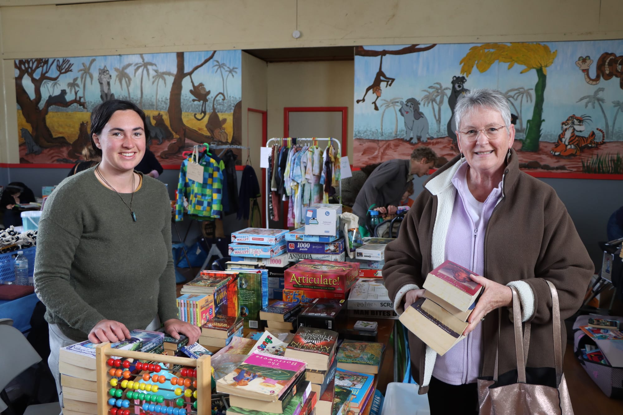Former Leongatha Scout Group leader Victoria Conroy sells books to Fay Sullivan.