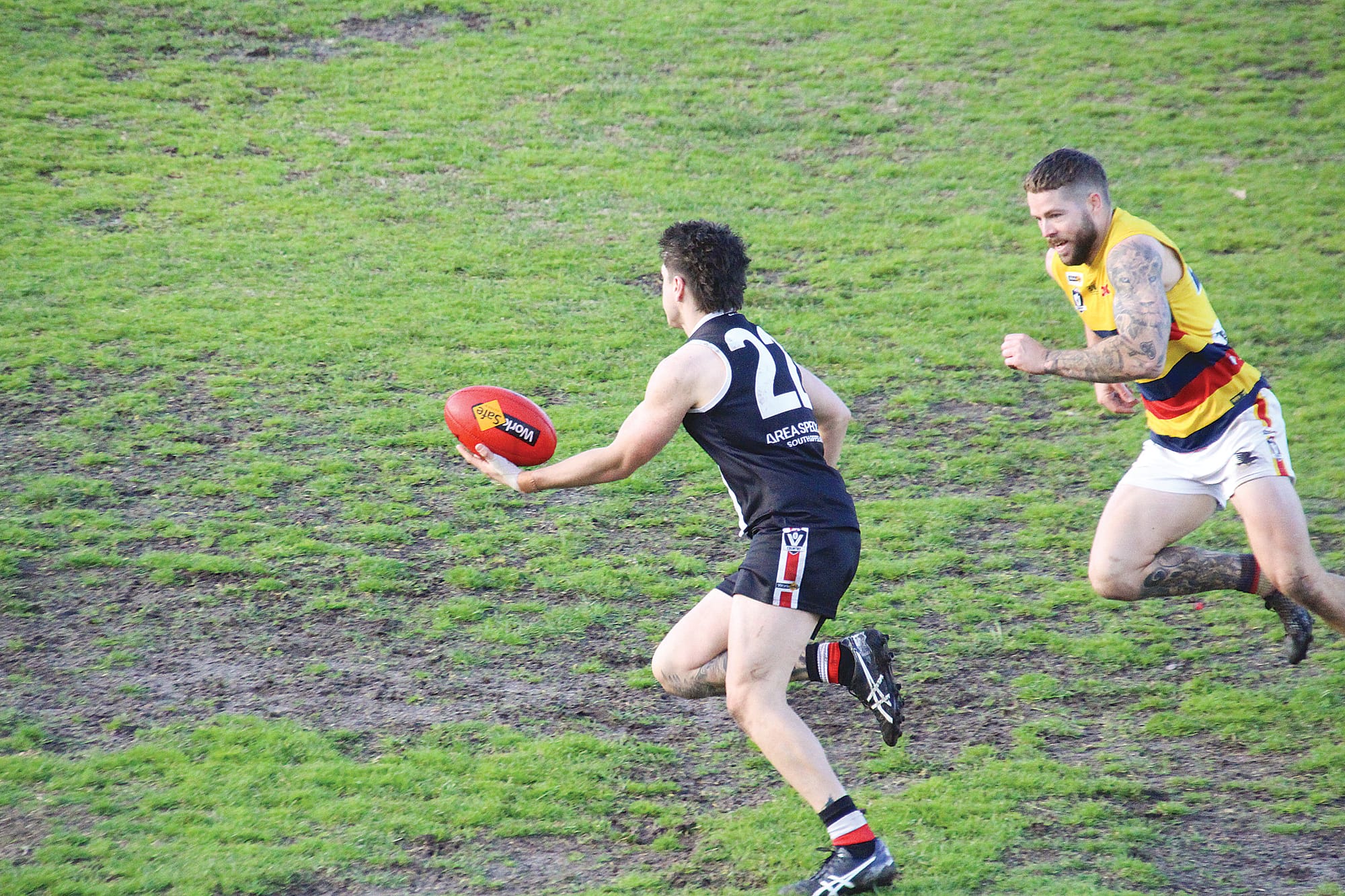 Rex Lazaros applies some fancy footwork to avoid the tackle and send the ball forward. 