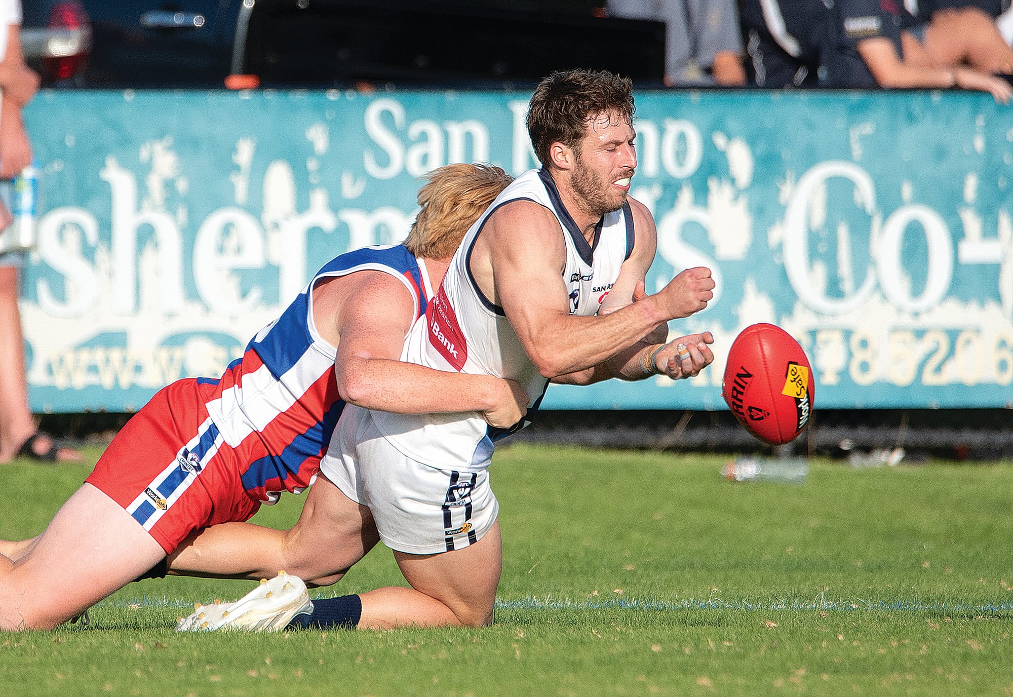 Nathan Foote looks to handball under pressure from his ‘Dogs opponent.