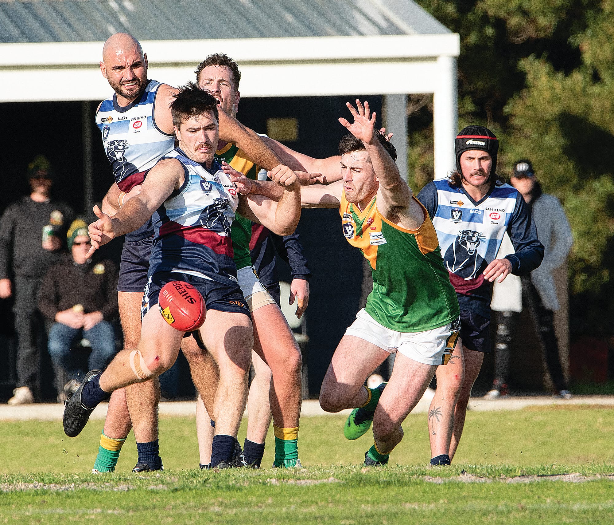 Kilcunda-Bass’ Lachlan Burns gets the kick away under pressure from Garfield.